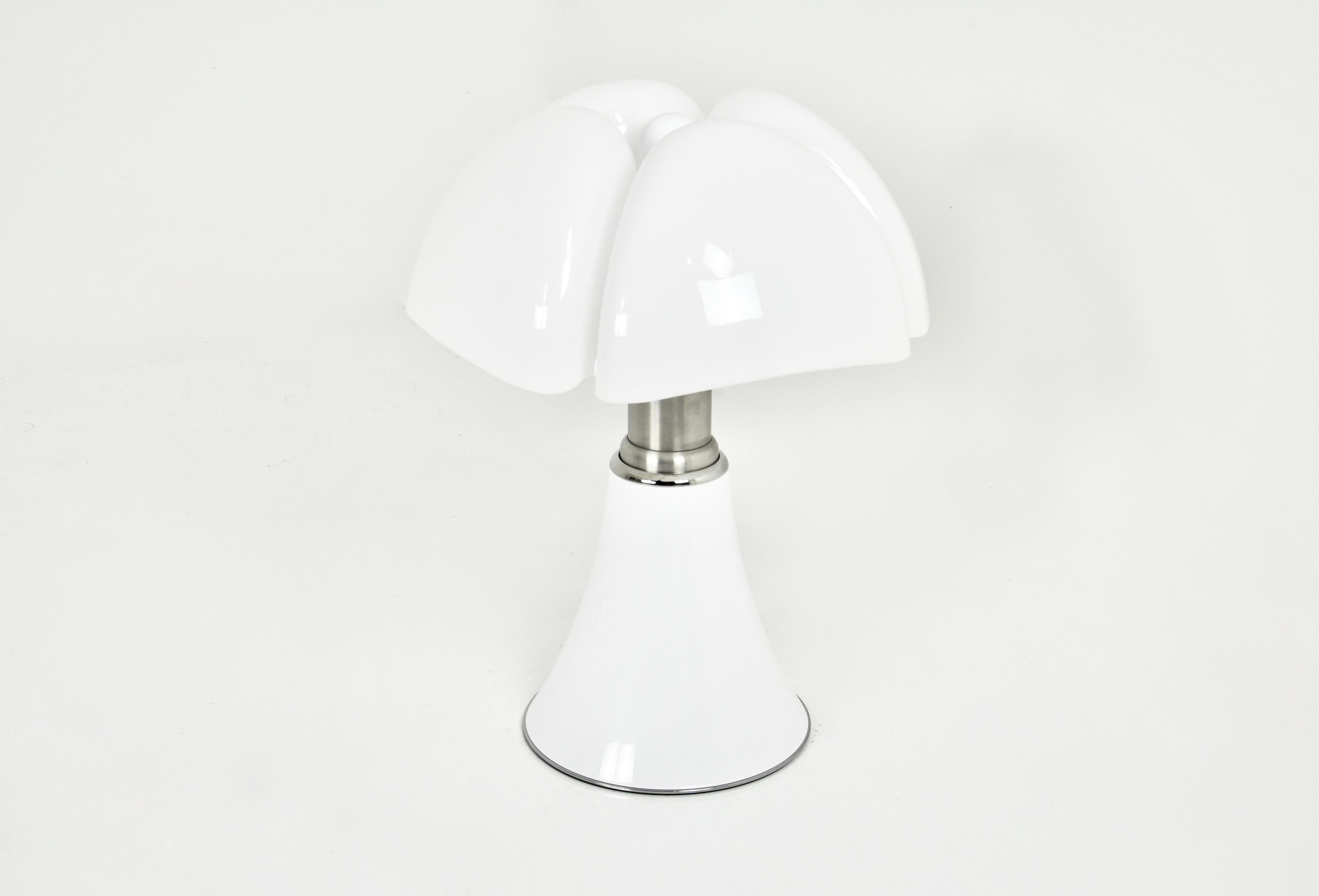 White lamp in metal and plastic by Gae Aulenti. Adjustable in height min: 70cm max: 90cm 
Stamped under the lamp.
