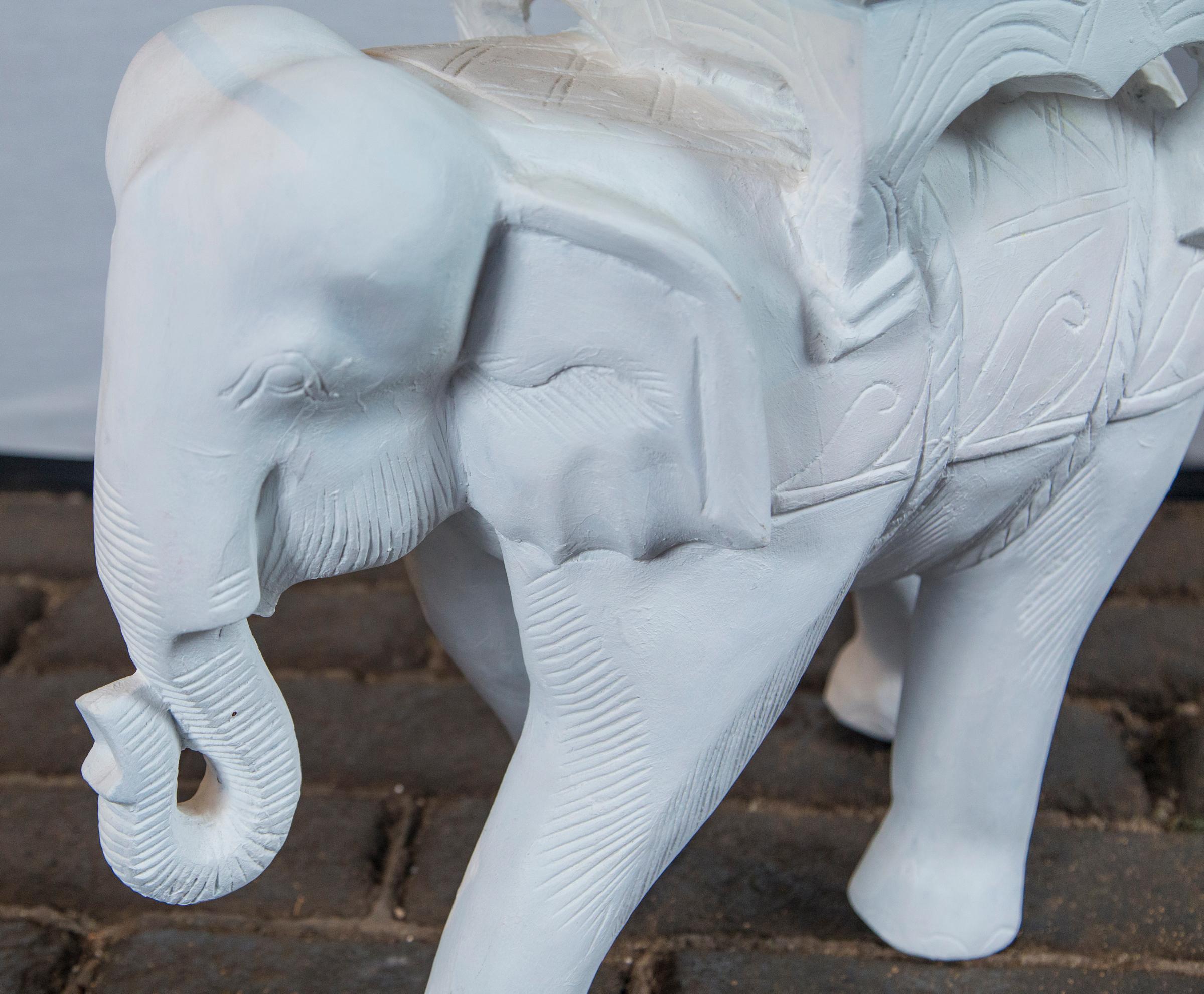 Charming little plaster elephant table base with a 24 inch diameter glass tabletop, circa 1970. Nicely detailed elephant.