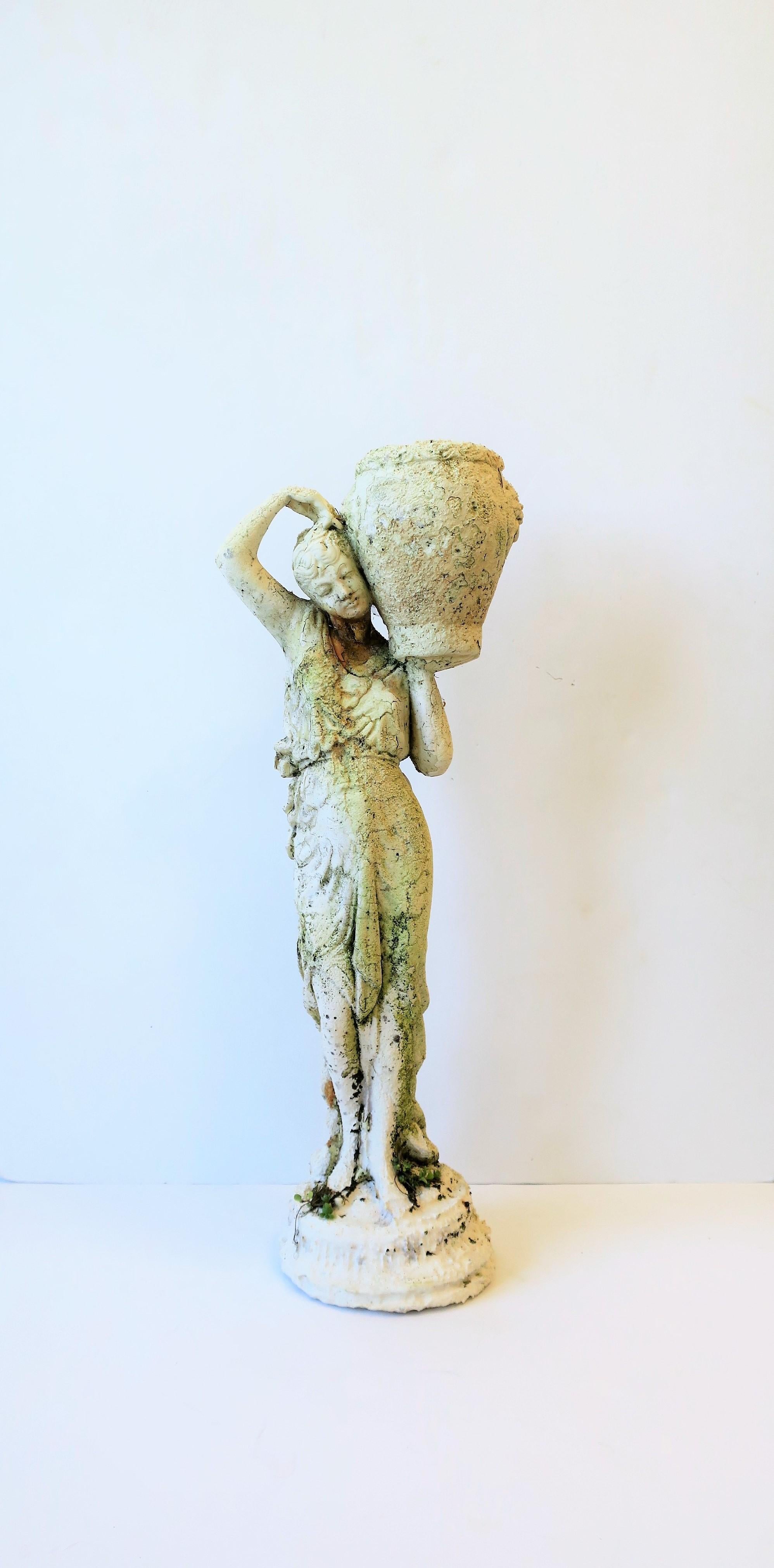 A beautiful cement Female garden sculpture piece with decorative planter pot, circa Mid-20th Century. Sculpture has beautiful details; she looks great from the front and the back as show in images. She holds a pot on her shoulder; pot has detailed