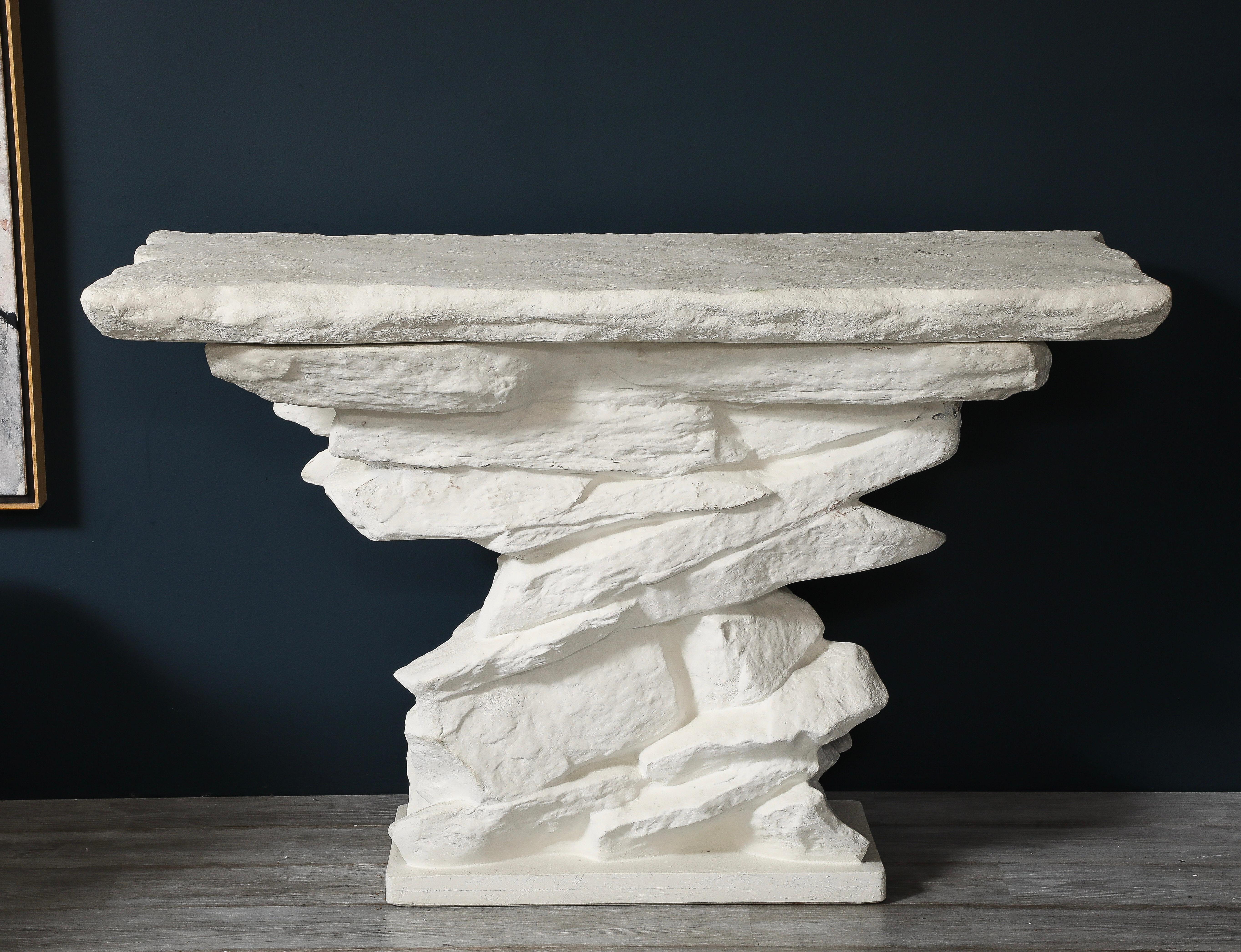 A striking grand quarry ledge plaster console, by Sirmos based on the iconic original design by Emilio Terry (1927). This impressive chalk-white plaster console, with its removable plaster top, evokes the look of stacked stone—at once organic,
