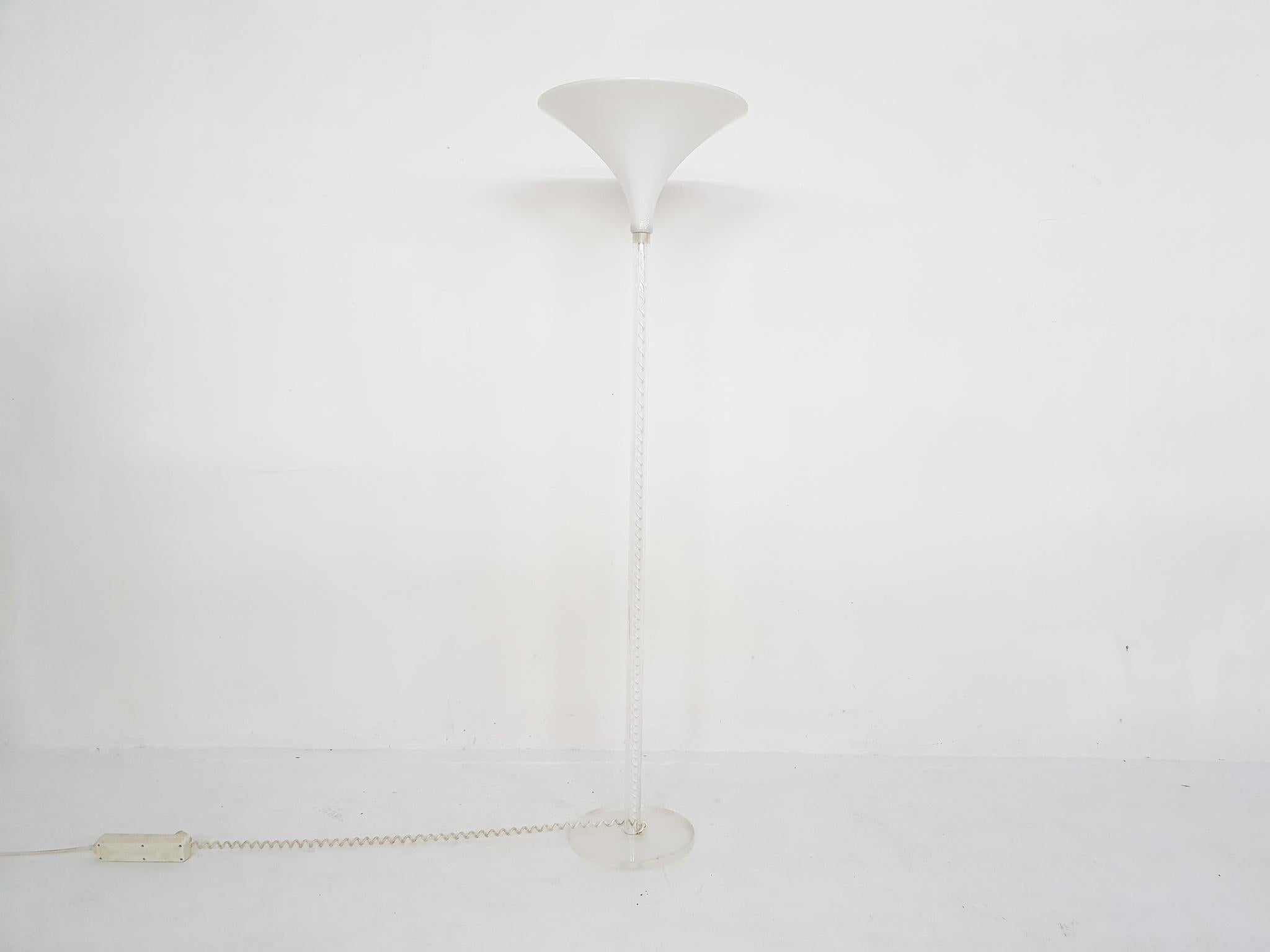 Plastic floor light with curled wire inside the lucite tube. The lamp does not have a switch, but we can add one if prefered.