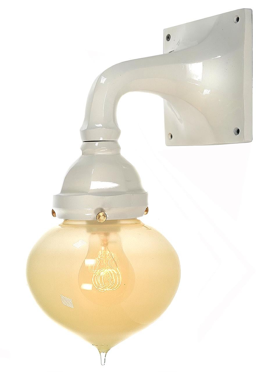The look is light and elegant in a classic traditional style. The fixture is a warm white baked on gloss enamel. The tipped onion shaped shade is hand-blown vaseline glass. We do have a good collection of these in stock.