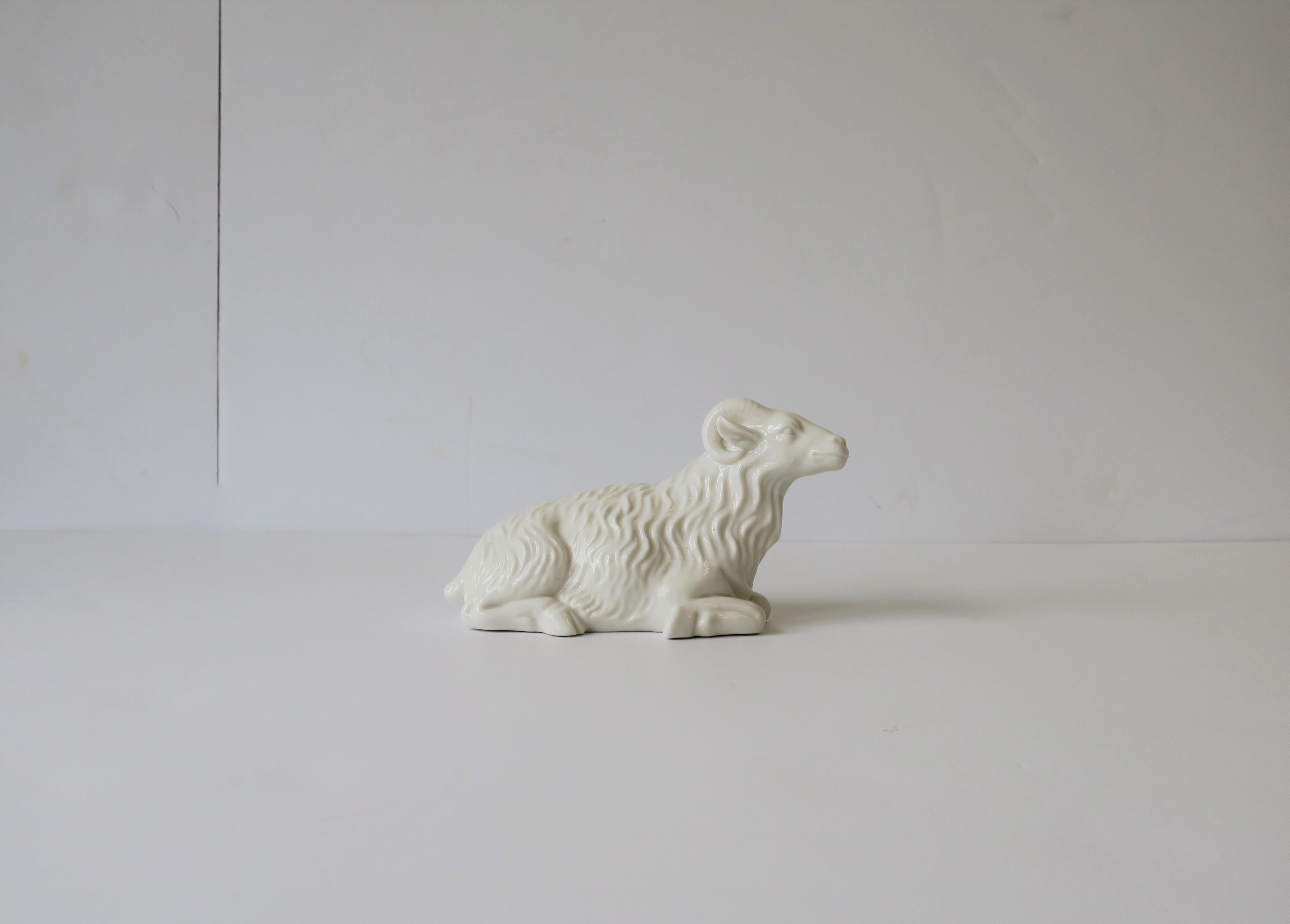 A great Hollywood Regency style white porcelain animal ram sculpture piece. Ram has fine details including its horns, face, hoofs, and coat, circa mid-20th century. Marked 
