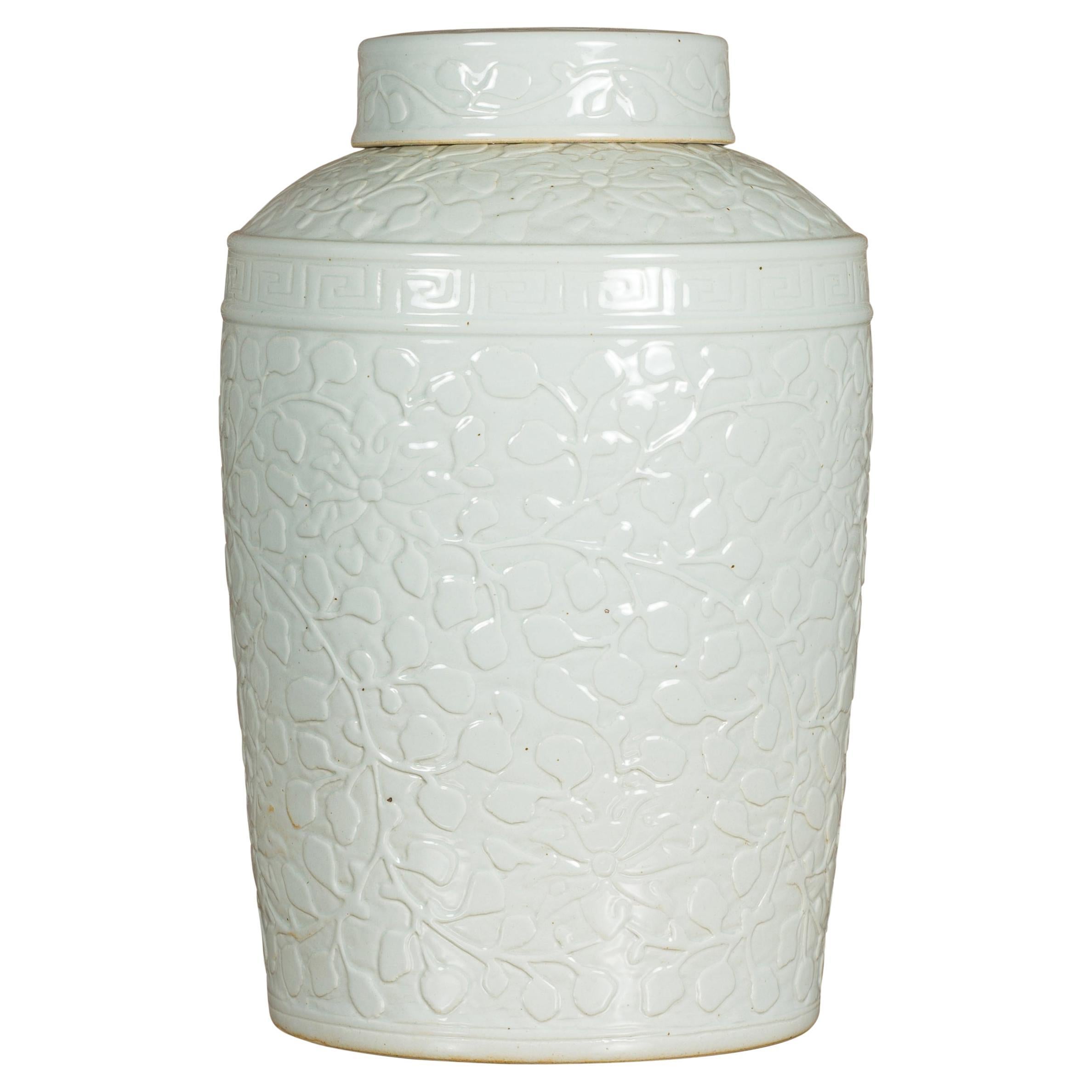 White Porcelain Asian Lidded Jar with Scrolling Foliage Motifs For Sale