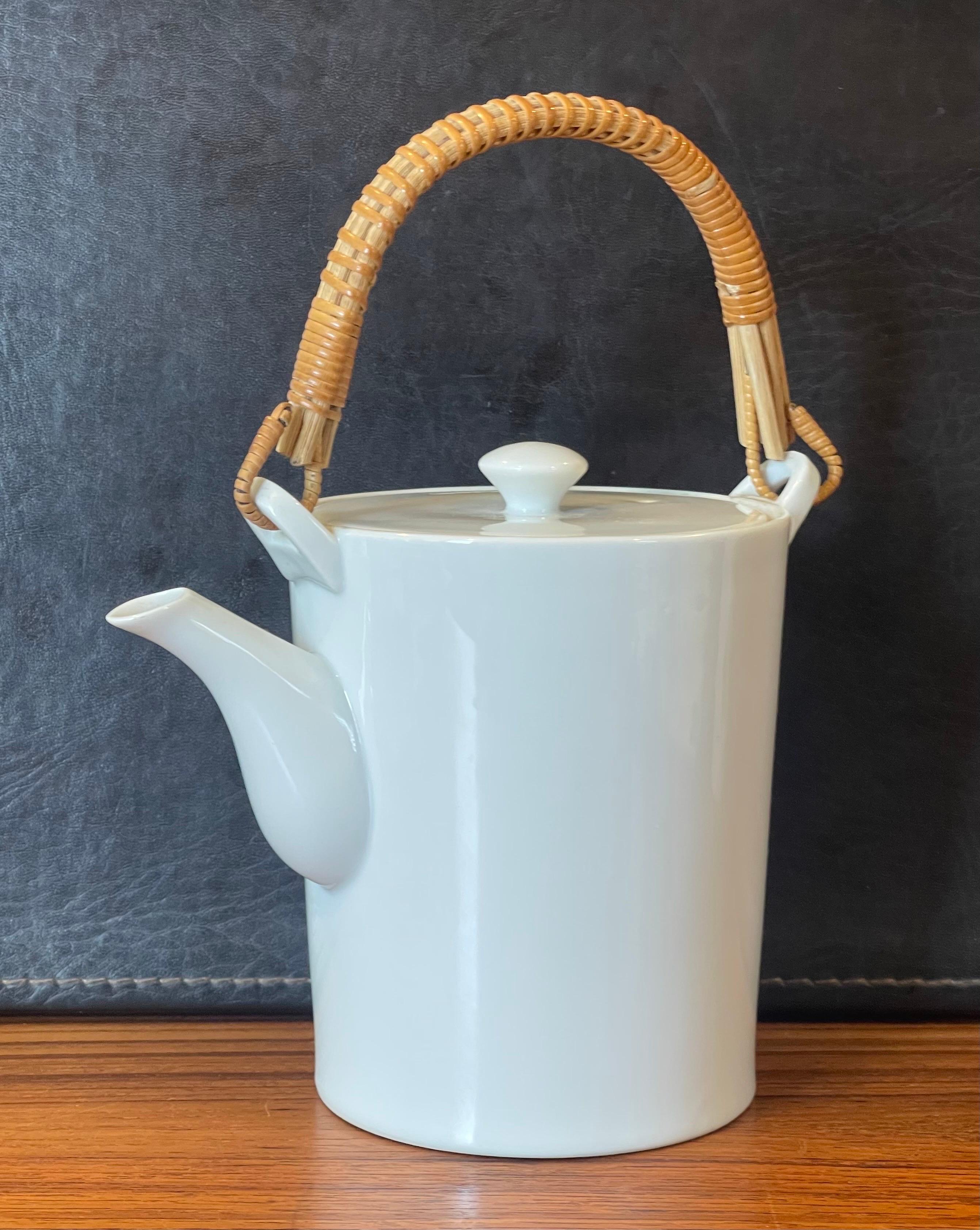 Rare white porcelain and cane handle teapot by Kenji Fujita for Freeman Lederman, circa 1950s. The pot is in very good vintage condition with no chips or cracks (some tea staining to the inside) and measures 5.25