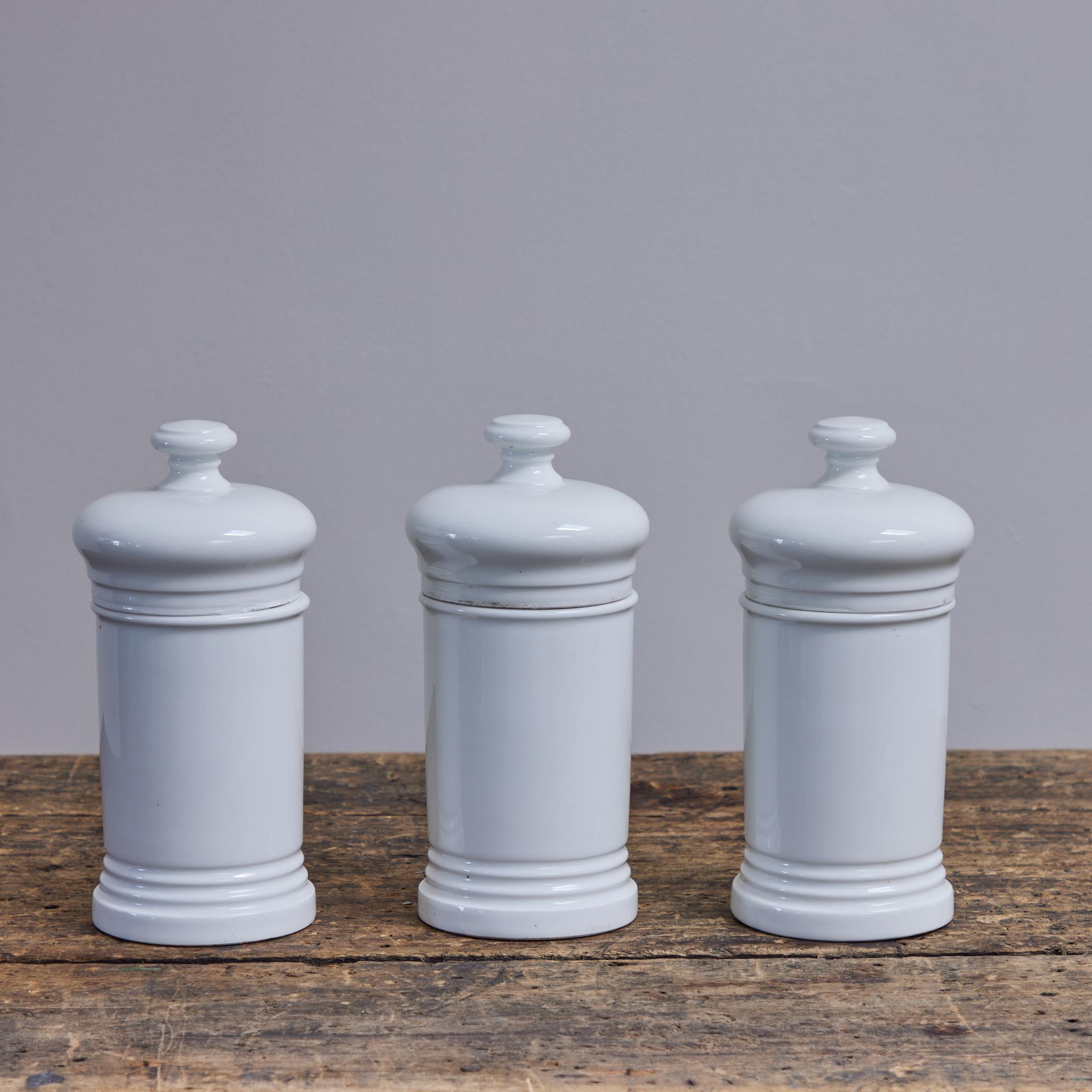 Cream white porcelain apothecary jar, hailing from late 19th-century Spain.  At once rustic and refined, the piece is highly versatile, and would make for especially excellent storage in a kitchen or bathroom setting. Once used for herb dispensary,