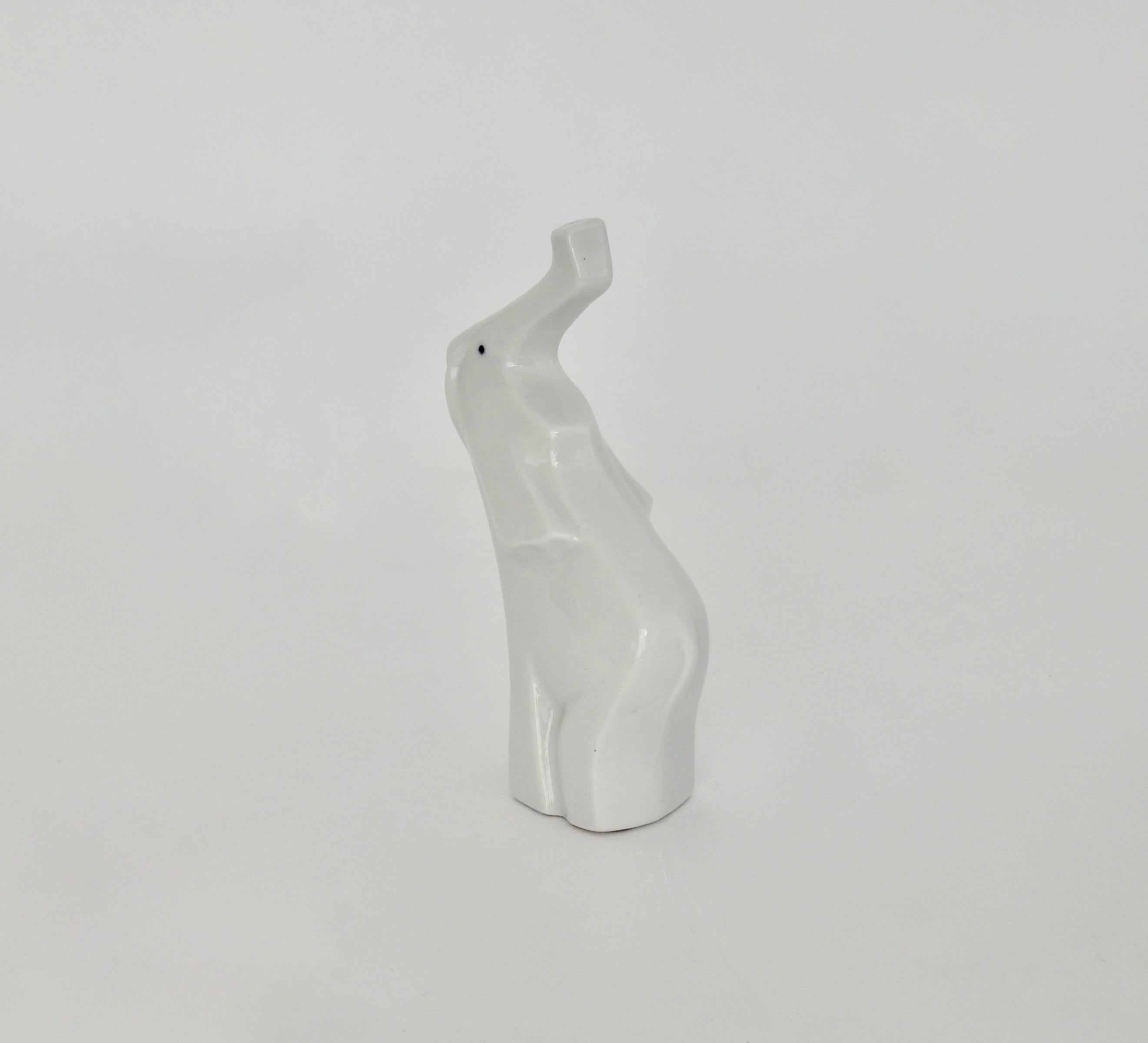 White porcelain cubist petite elephant figurine with trunk up
Measures: 5.13