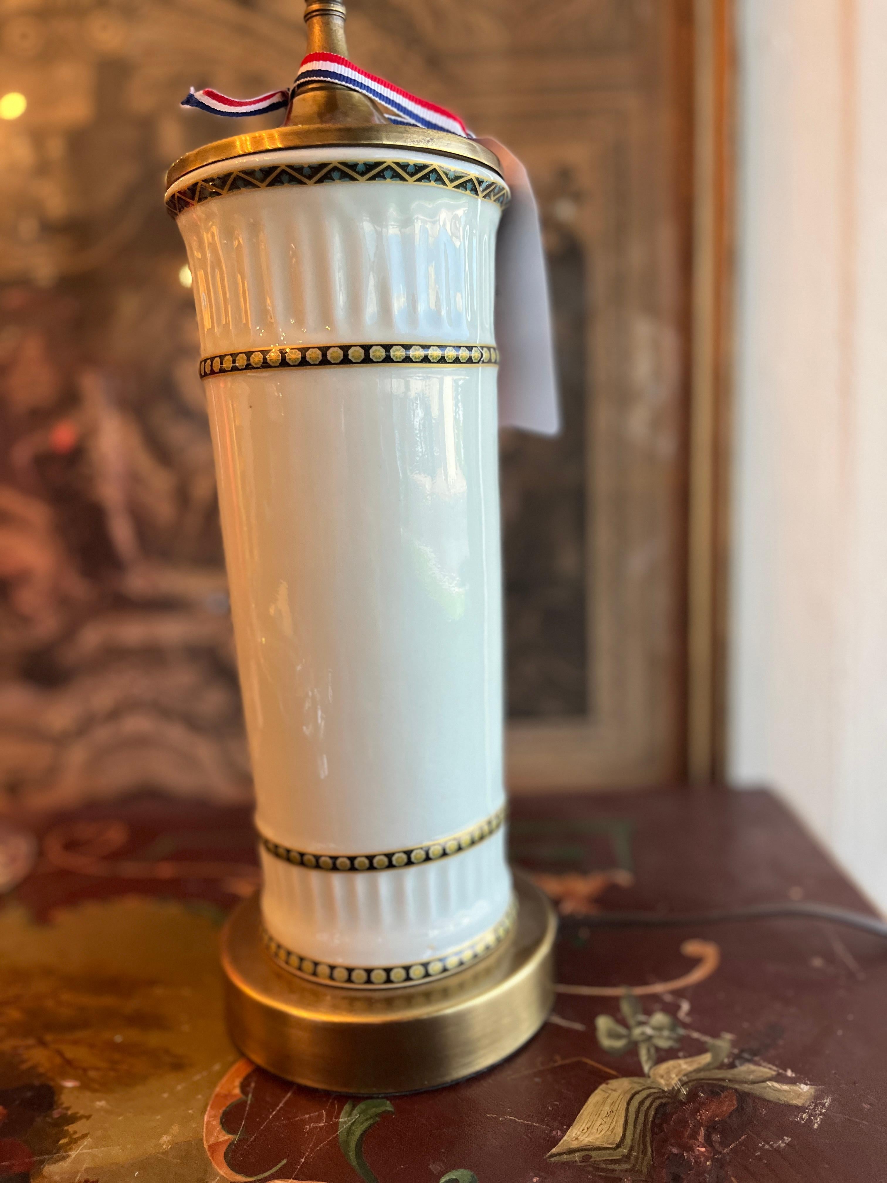 White Porcelain Lamp with Brass Base.  Uncertain of origin, appears to be late 19th century French.  Shade not included.