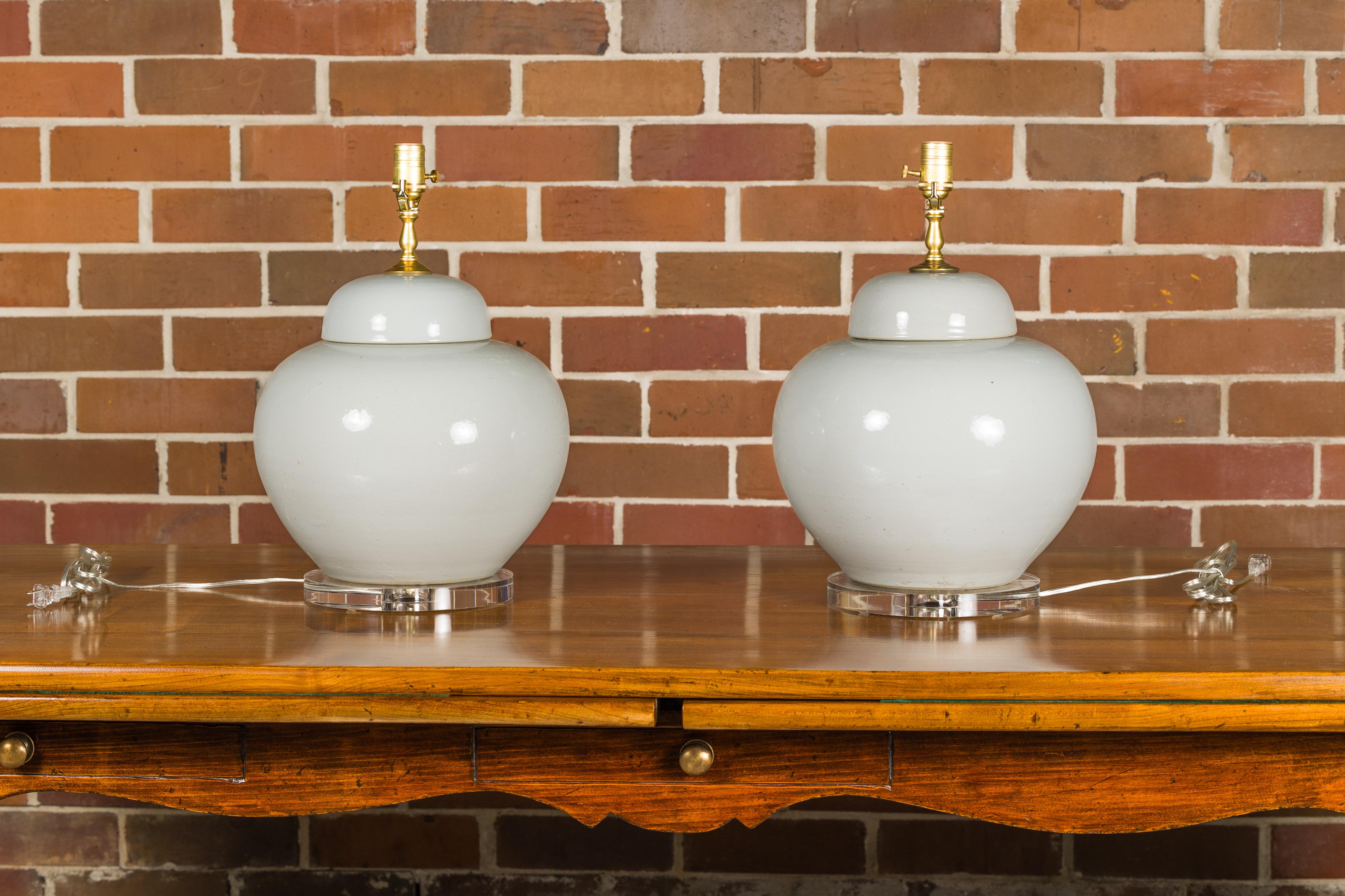 White Porcelain Lidded Urns Made into Wired Table Lamps on Lucite Bases, a Pair In Good Condition For Sale In Atlanta, GA