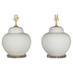 White Porcelain Lidded Urns Made into Wired Table Lamps on Lucite Bases, a Pair