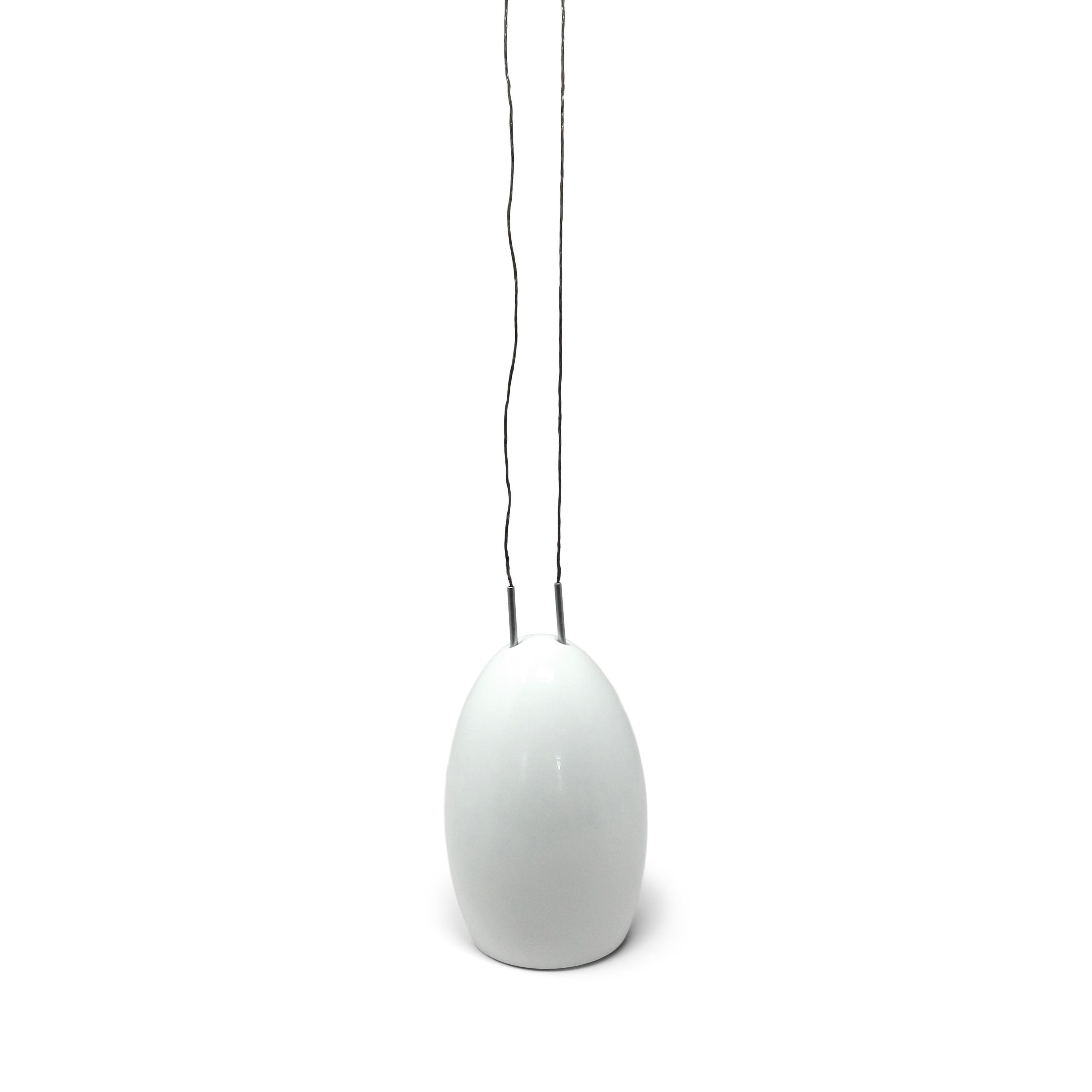 From the Tobias Grau designed Oh China Collection produced by Grau's eponymous company, the Oh pendant lamp is made of fine bone china in a simple and beautiful form. Suspended on two cables and height-adjustable, the egg shaped shade can go up or