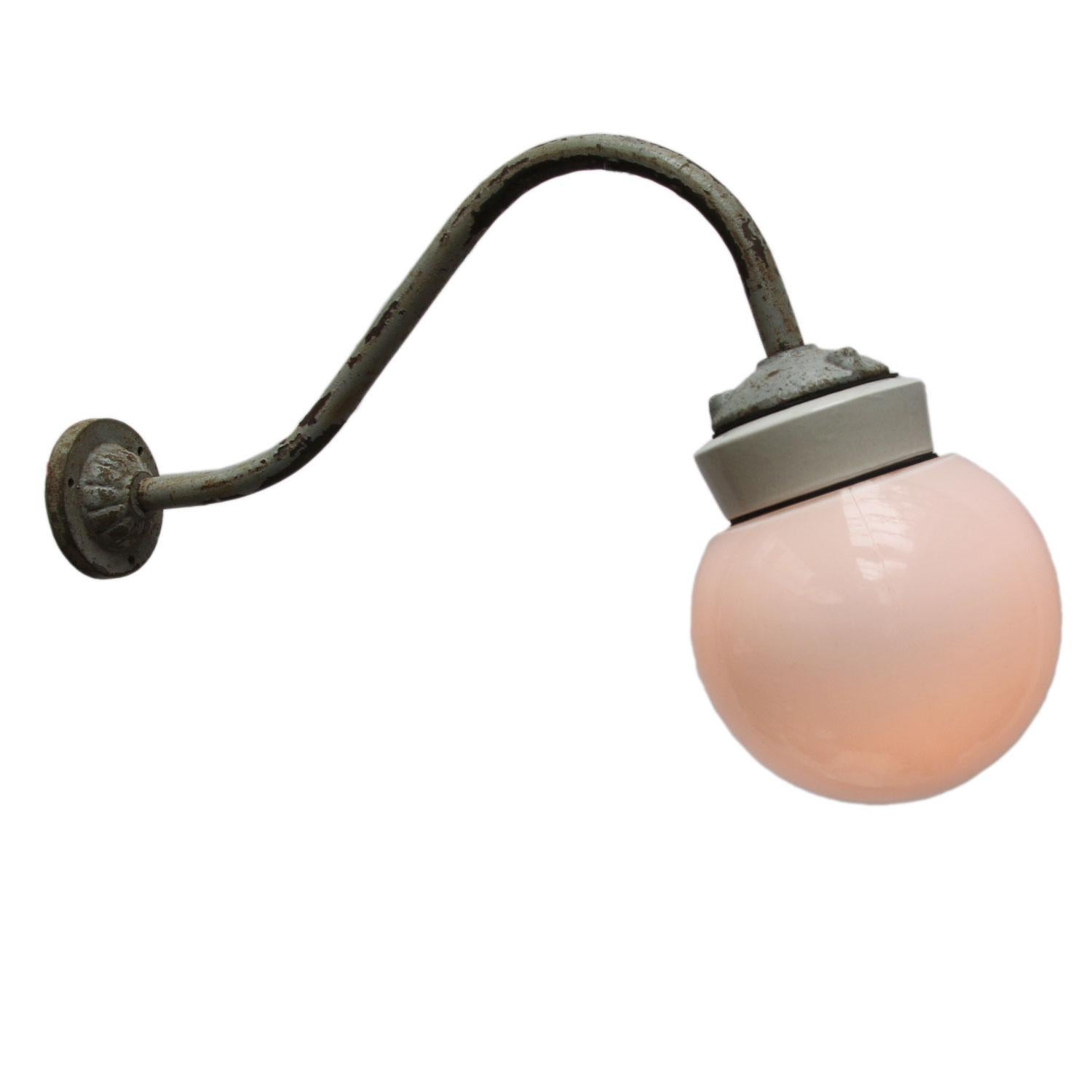 Vintage industrial wall light.
Cast iron and porcelain top. Opaline glass globe. 
Diameter cast iron wall mount: 9 cm, three holes to secure.

Weight: 2.0 kg / 4.4 lb

Priced per individual item. All lamps have been made suitable by international
