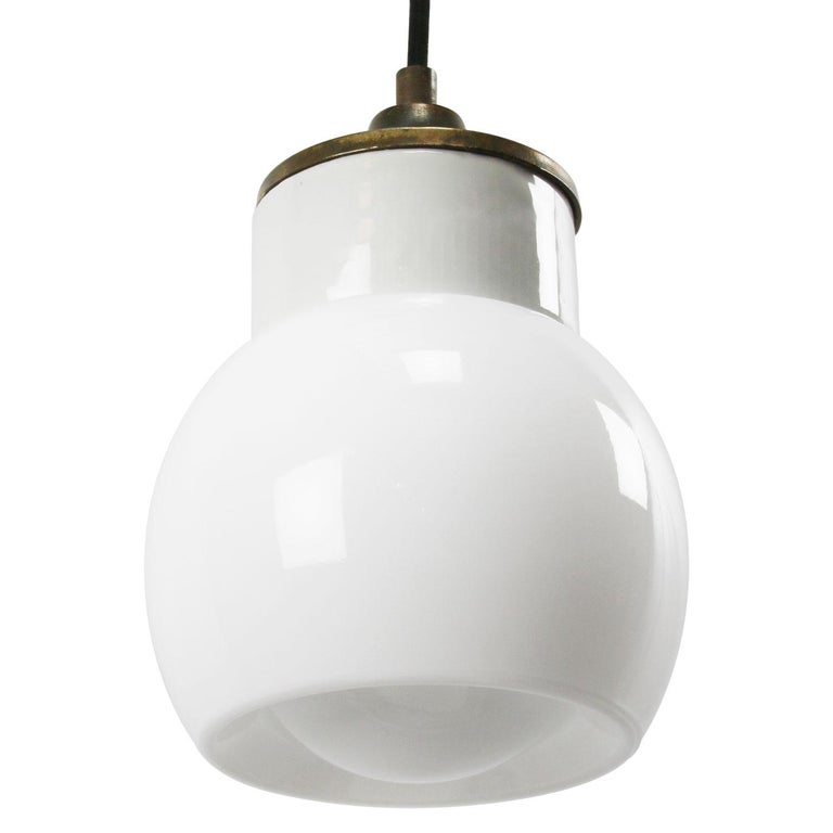 Porcelain industrial hanging lamp.
White porcelain, brass and opaline glass.
wired for 110 volt / or 220 volt.
2 conductors, no ground. 

Weight: 1.40 kg / 3.1 lb

Priced per individual item. All lamps have been made suitable by international
