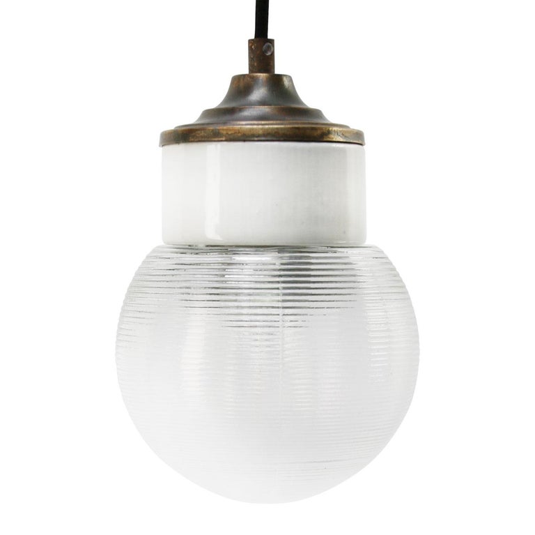 Porcelain industrial hanging lamp.
White porcelain, brass and clear striped glass.
2 conductors, no ground.

Weight: 1.20 kg / 2.6 lb

Priced per individual item. All lamps have been made suitable by international standards for incandescent