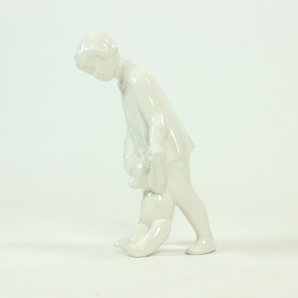 Vintage sculpture of a girl walking with a teddybear. Produced in Czechoslovakia in 1960s. The sculpture is made od glazed porcelaine in pure white color. Beautiful item with some wear showing. Some age 