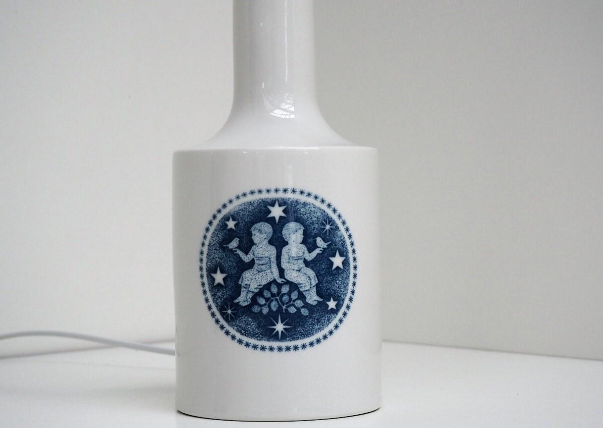 Danish porcelain lamp designed by Fog & Mørup for Royal Copenhagen in the 1960s and painted by Kaj Lange. On the base is an illustration of the Twin Zodiac Sign. On the back is written tvillingerne (