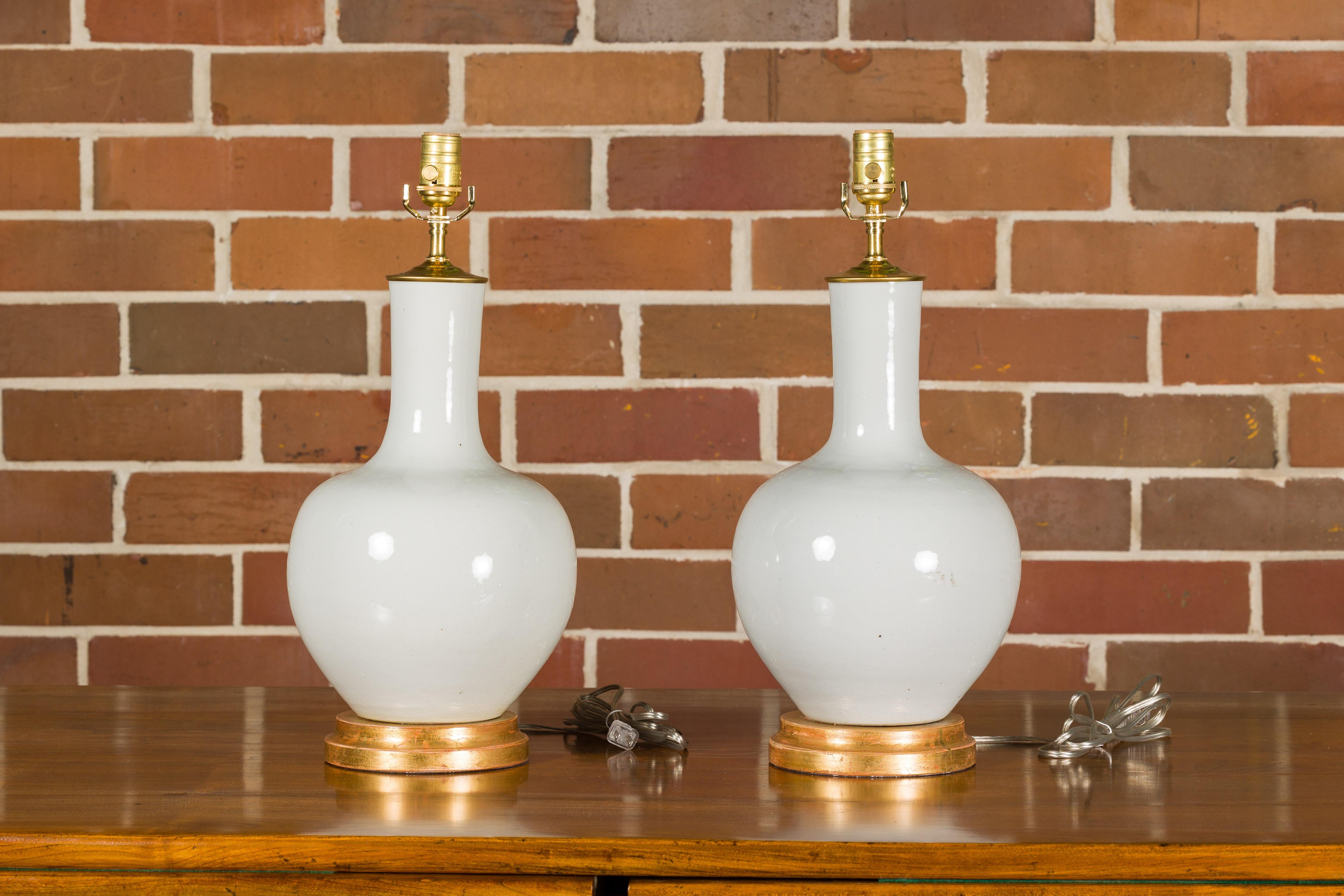 White Porcelain Vases Made into Wired Table Lamps on Giltwood Bases, a Pair 1