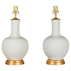White Porcelain Vases Made into Wired Table Lamps on Giltwood Bases, a Pair