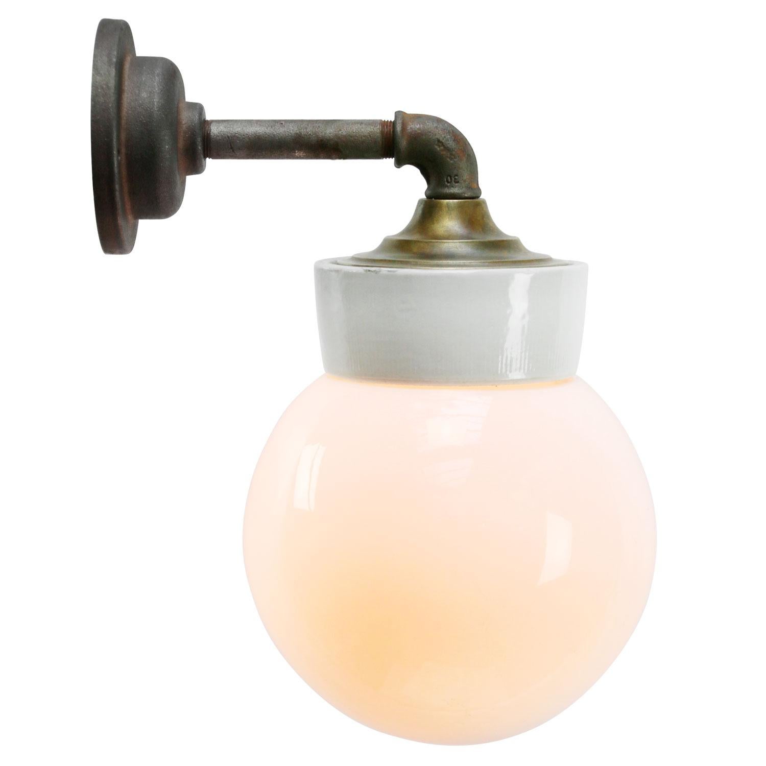 Porcelain Industrial wall lamp.
White porcelain, brass and cast iron
Opaline Milk glass.
2 conductors, no ground.

Diameter cast iron wall piece 10 cm. 2 holes to secure.

Weight: 2.25 kg / 5 lb

Priced per individual item. All lamps have