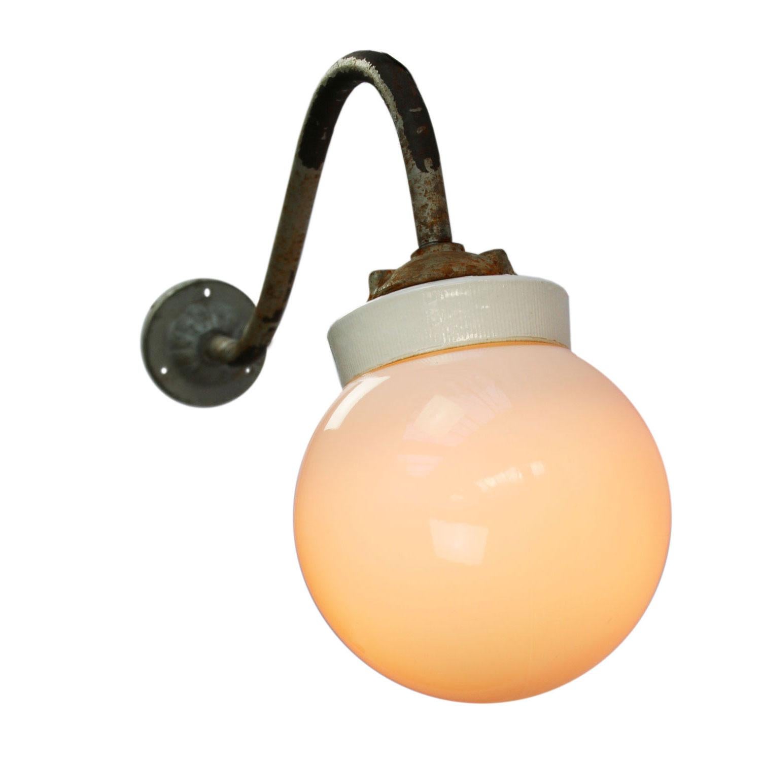 Industrial wall light.
Cast iron and porcelain top, white opaline glass.
Diameter cast iron wall mount: 9 cm, 3 holes to secure.

Weight: 2.00 kg / 4.4 lb

Priced per individual item. All lamps have been made suitable by international standards for