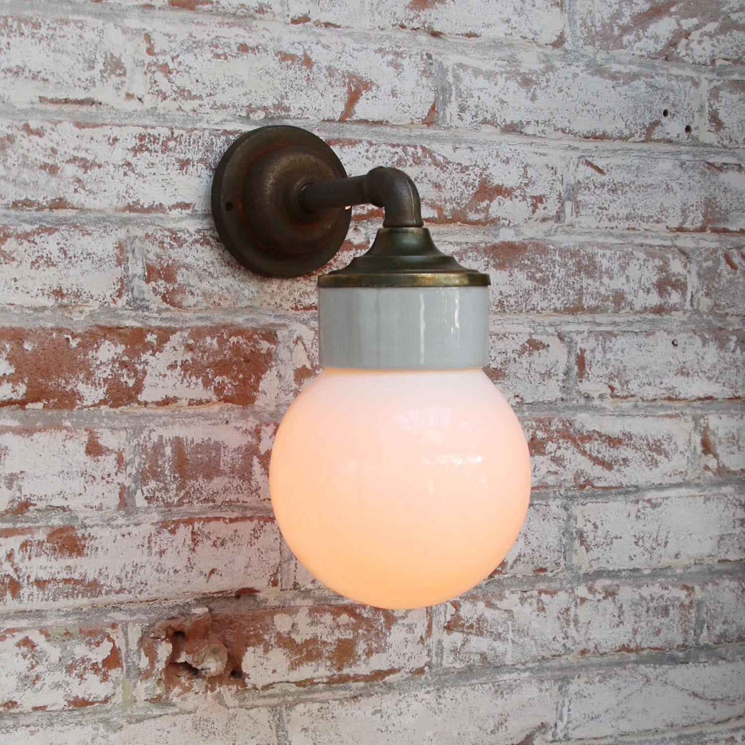 Porcelain Industrial wall lamp.
White porcelain, brass and cast iron
Opaline / Milk glass.
2 conductors, no ground.

Diameter wall mount 10.5 cm / 4”

for use inside only

Measures: Weight: 2.05 kg / 4.5 lb

Priced per individual item. All lamps