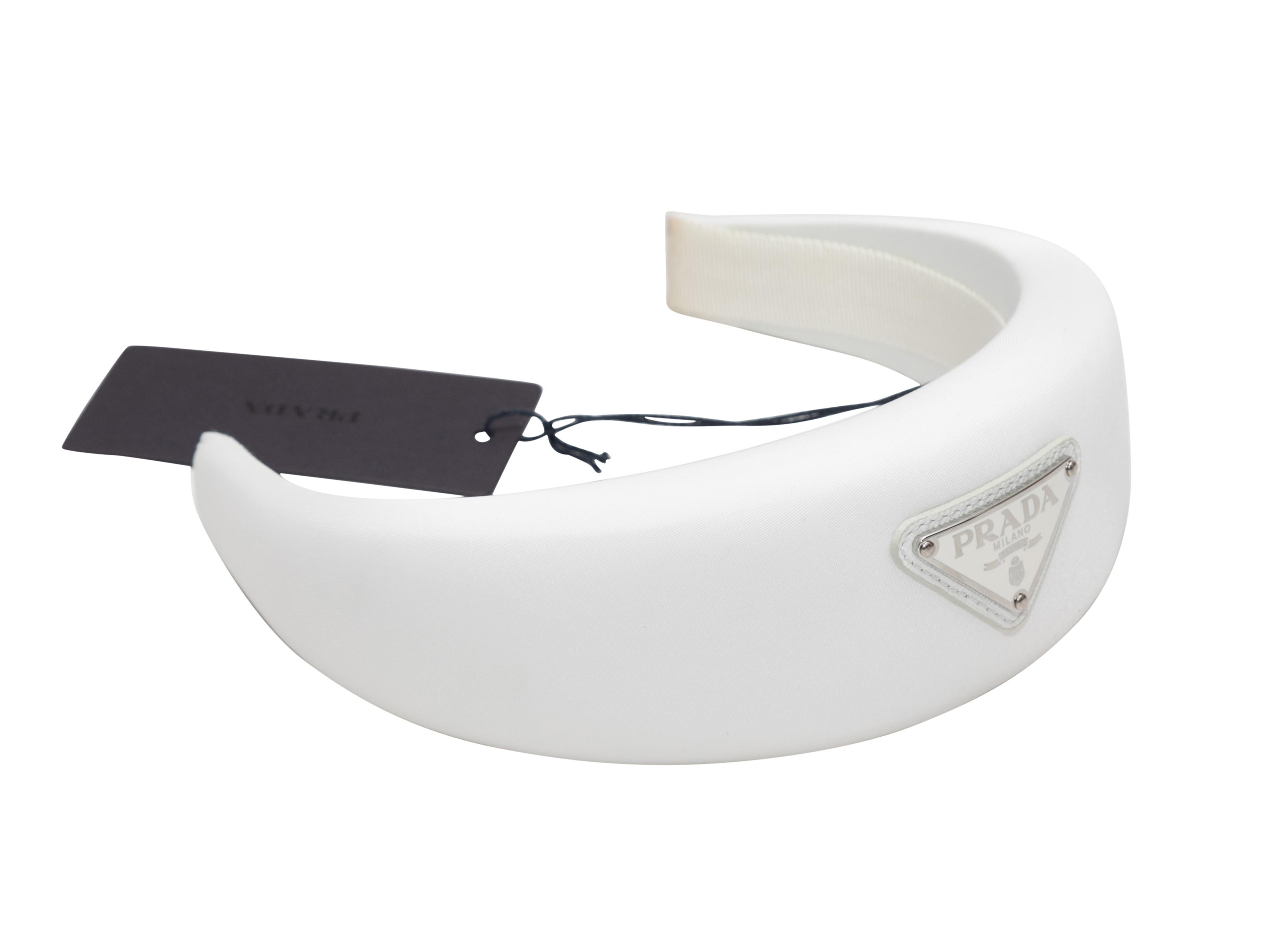 White padded Re-Nylon headband by Prada. Logo adornment at top. 2.75