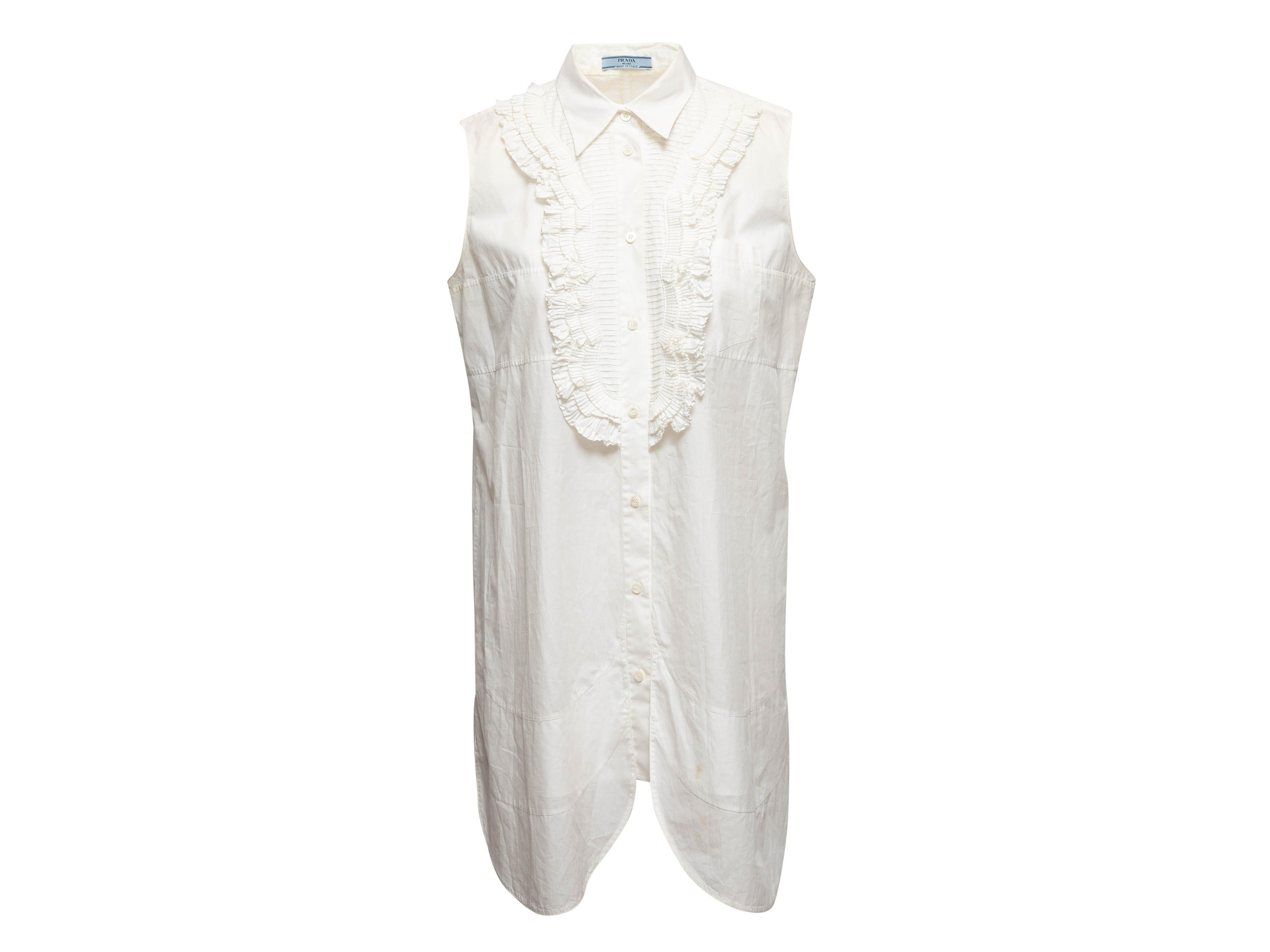 White sleeveless button-up dress by Prada. Pointed collar. Ruffle trim at front. Button closures at center front. 40