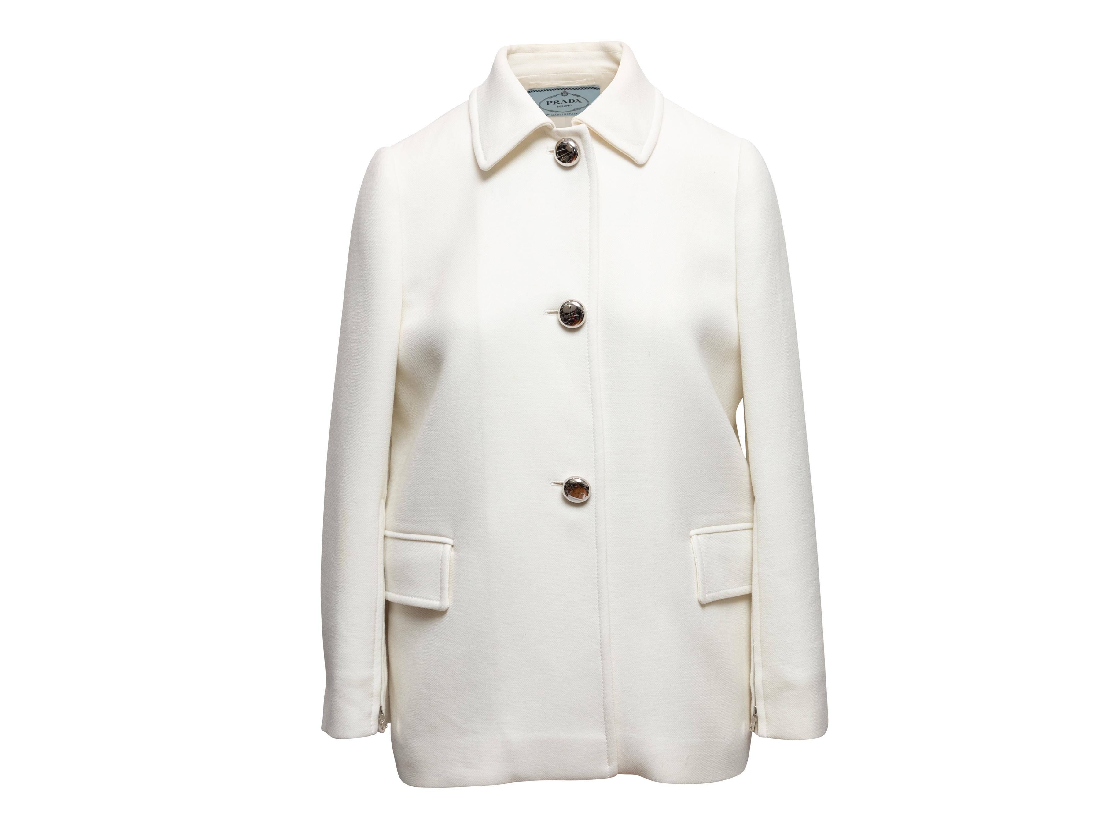 White wool jacket by Prada. Pointed collar. Dual hip pockets. Silver-tone button closures at front. 37