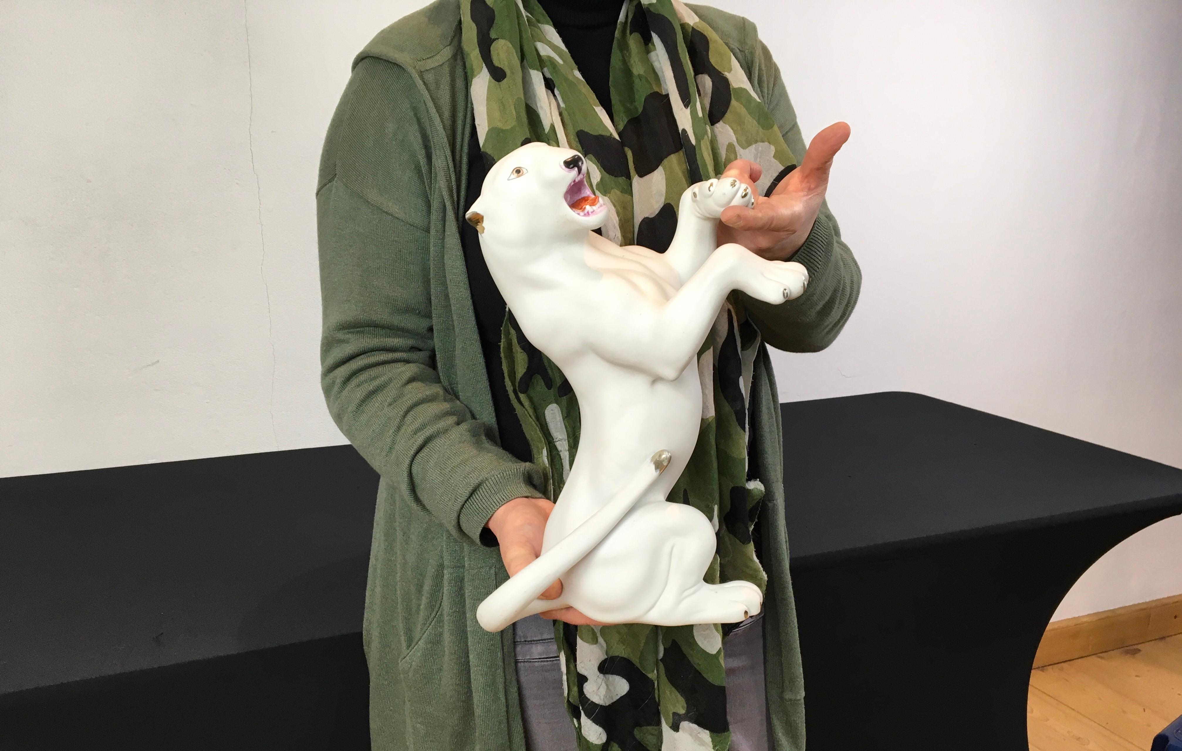 White Puma Sculpture. 
A bisquit - unglazed porcelain puma sculpture. 
This White Puma Sculpture is very expressive and has hand-painted golden accents on the claws, ears and tale. It's a stylish detailed animal sculpture; look at the mouth, tongue