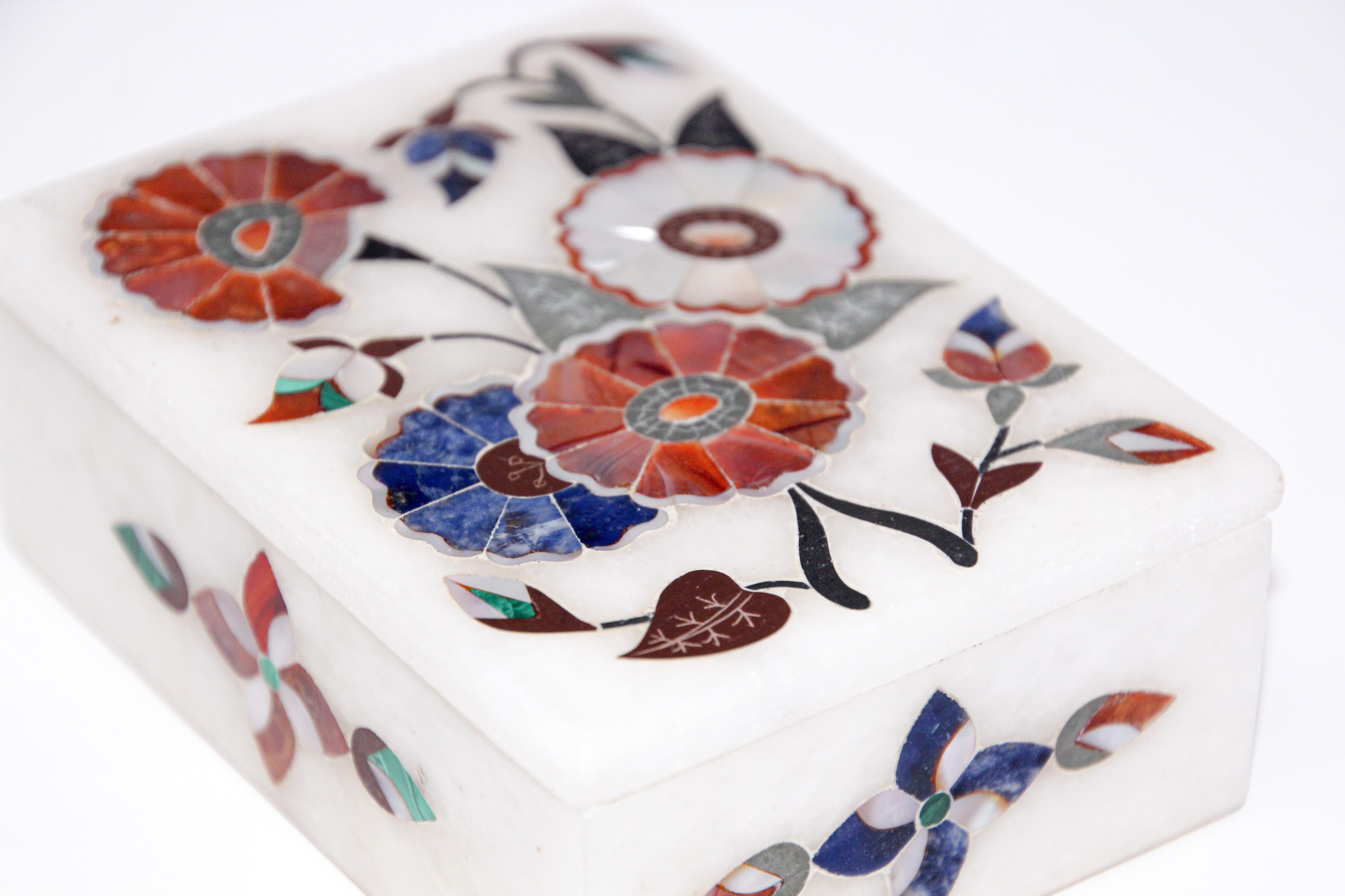 Rajasthani inlaid marble decorative rectangular box in Pietra Dura work.
Jewelry box with semi precious stone handcrafted marble inlaid with semi precious stones, jasper, carnelian for orange.
It is the same craftwork that you see in the Taj