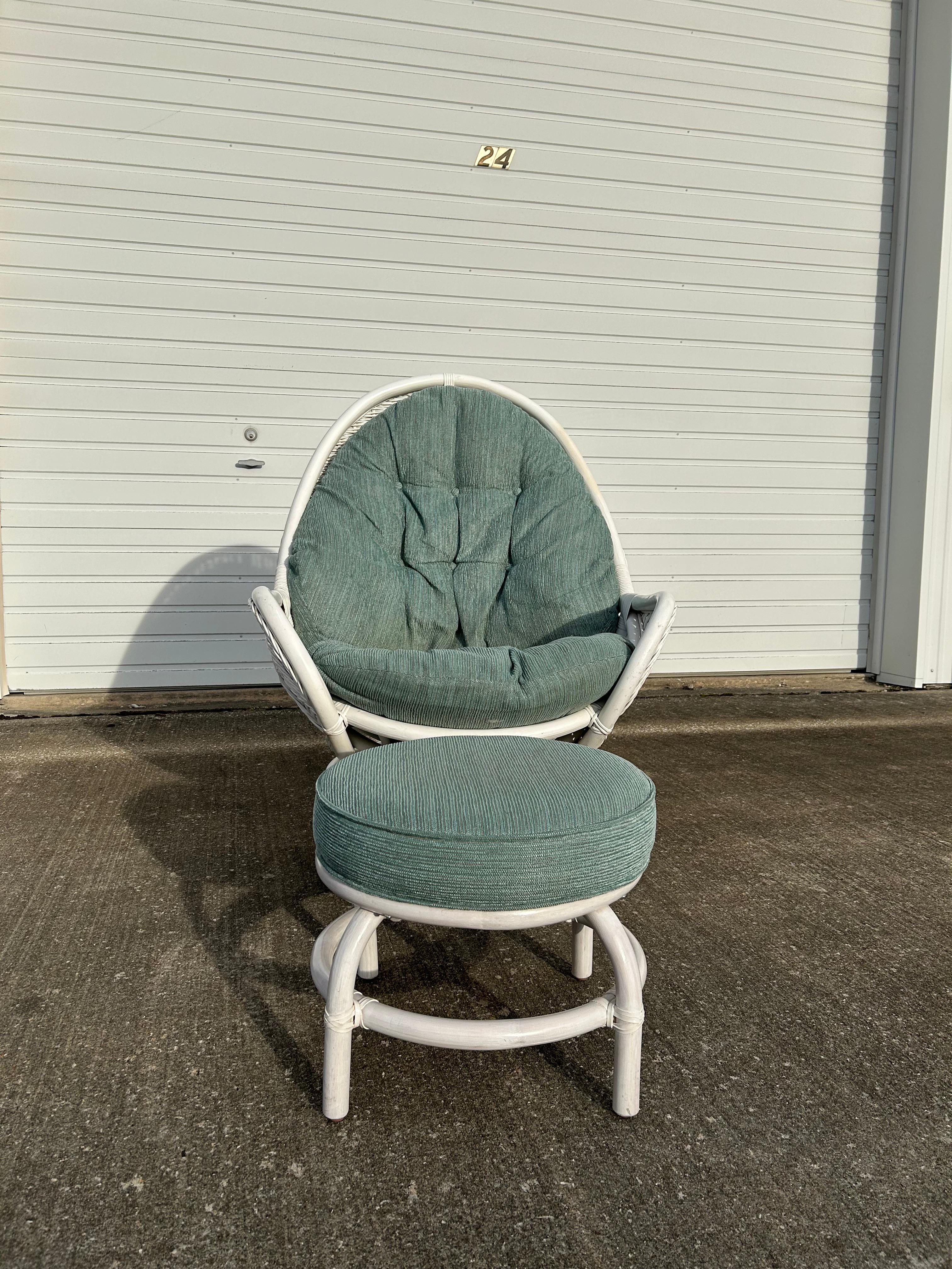 Rare and hard to find White Rattan Upholstered Egg Chair with Ottoman. The chair swivels and reclines when you sit back in it. See video for a full presentation of it. The upholstery is still in its original fabric and has not been changed. It does
