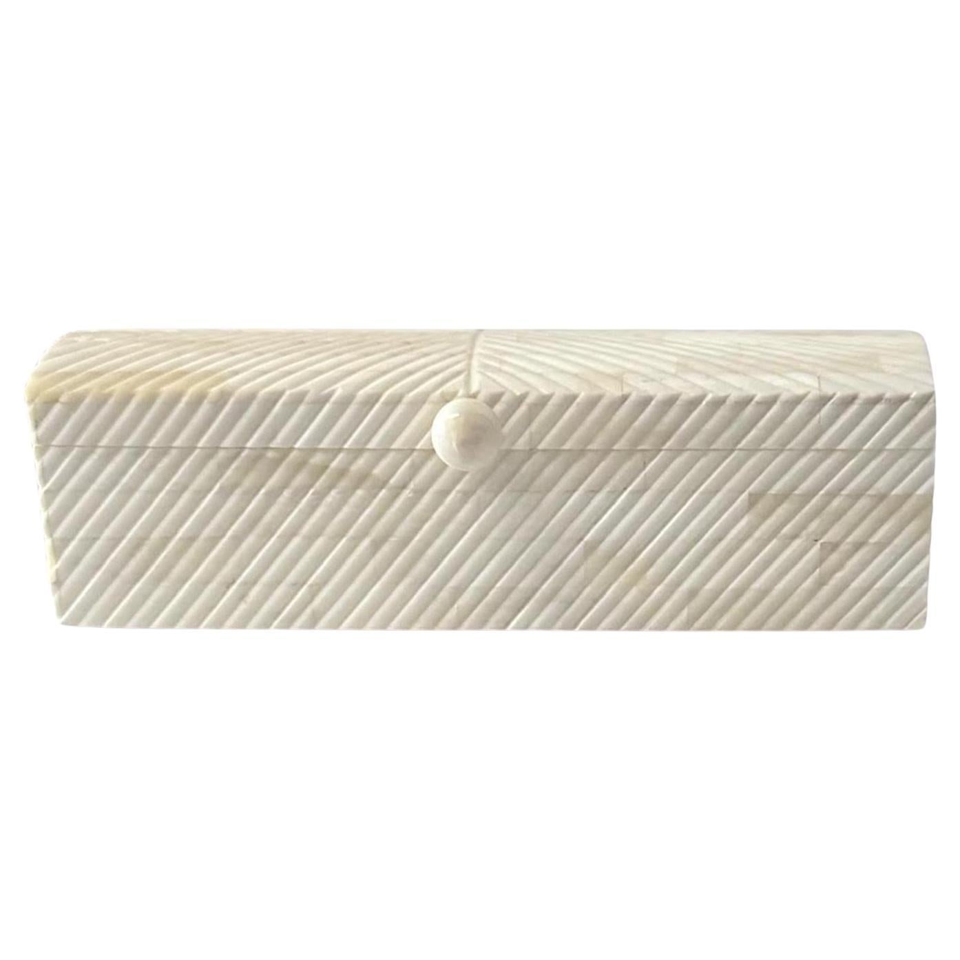 Contemporary Indian rectangular shaped bone box with attached lid.
Decorative diagonally shaped ribbed design.
Nob at opening.
Part of a large collection.