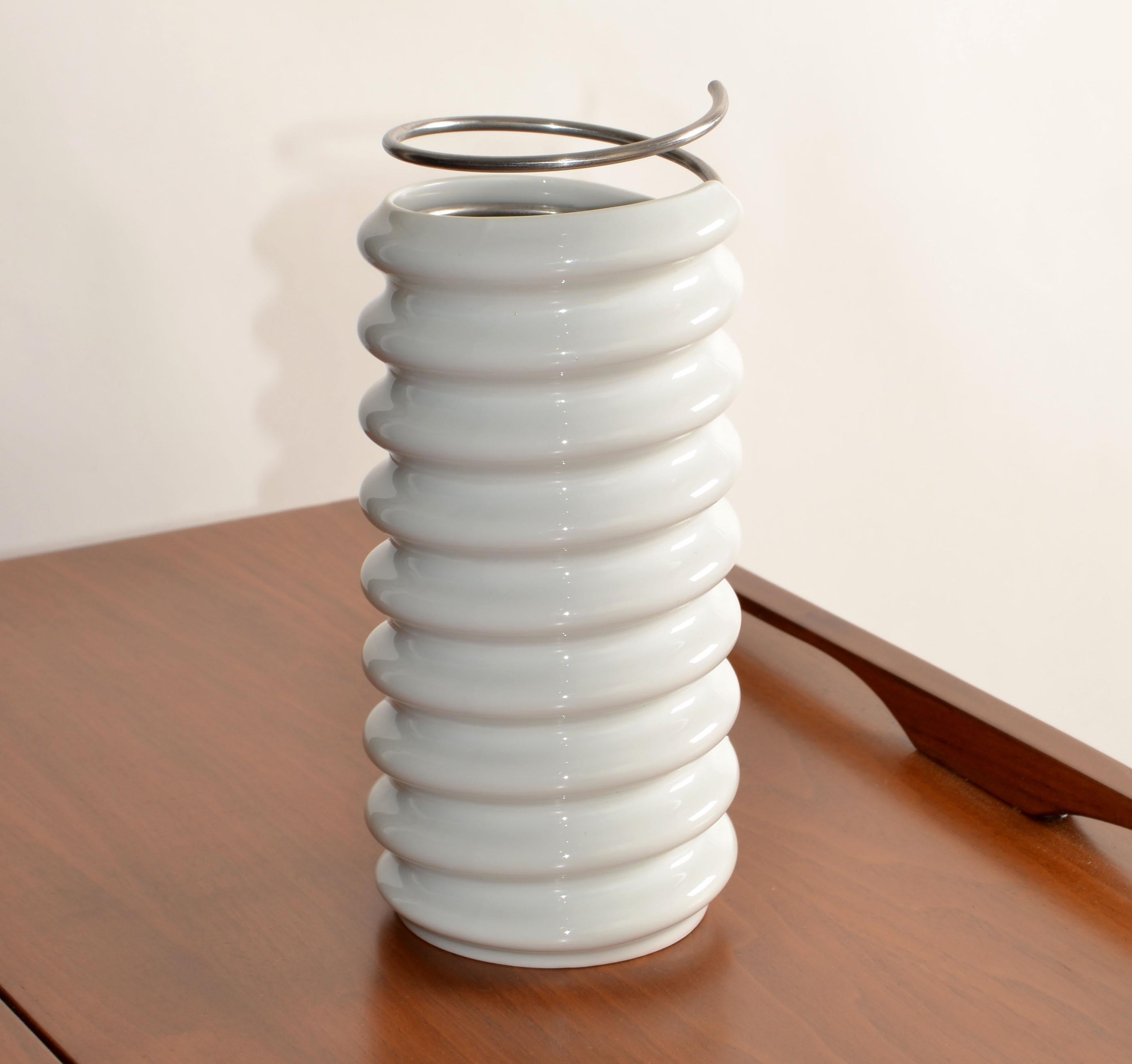 The Ron Arad Coil Vase, also known as the Ringoletto Vase, is a unique piece designed by Israeli designer Ron Arad for Rosenthal Studio Line. This vase is notable for its combination of materials and innovative design. It features a spiral of glazed