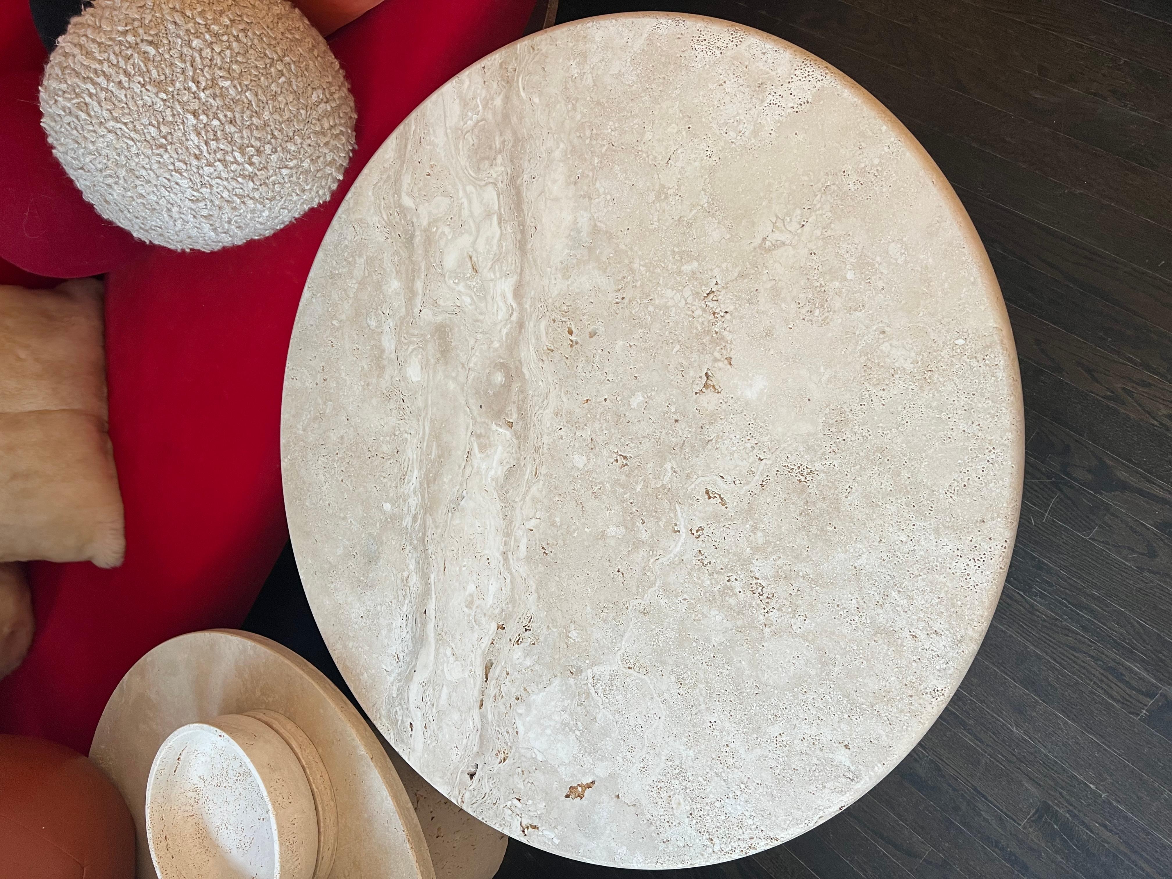 White Roman travertine table by Le Lampade. Measure 18.25'' height x 41''' diameter 
Round travertine top supported by a travertine column shaped base. These tables can be custom made.