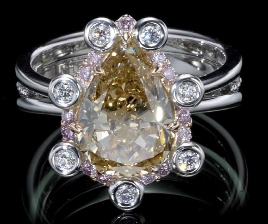 Immerse yourself in the exquisite allure of this 18k White & Rose gold ring, featuring an extraordinary centerpiece—a Fancy Yellow Pear Diamond. Weighing 4.02 carats, this diamond showcases a captivating Fancy Brownish Yellow color grade and SI2