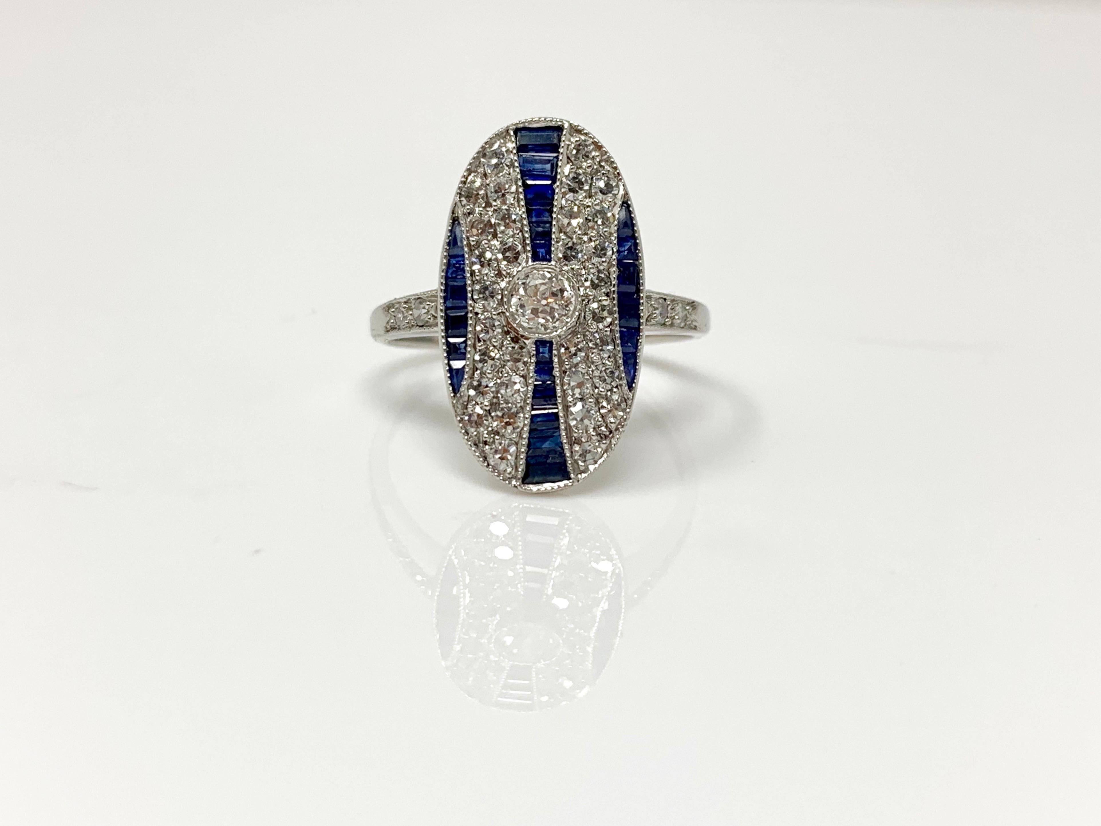 This gorgeous and one of a kind ring by Moguldiam Inc  is custom handmade in platinum. 

White diamond weight : 0.65 carat with GH color and VS clarity 
Blue sapphire weight : 0.60 carat 
Ring size : 6 3/4 and can be resized 