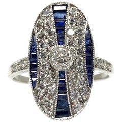 White Round Brilliant Diamond and Blue Sapphire Ring in Platinum