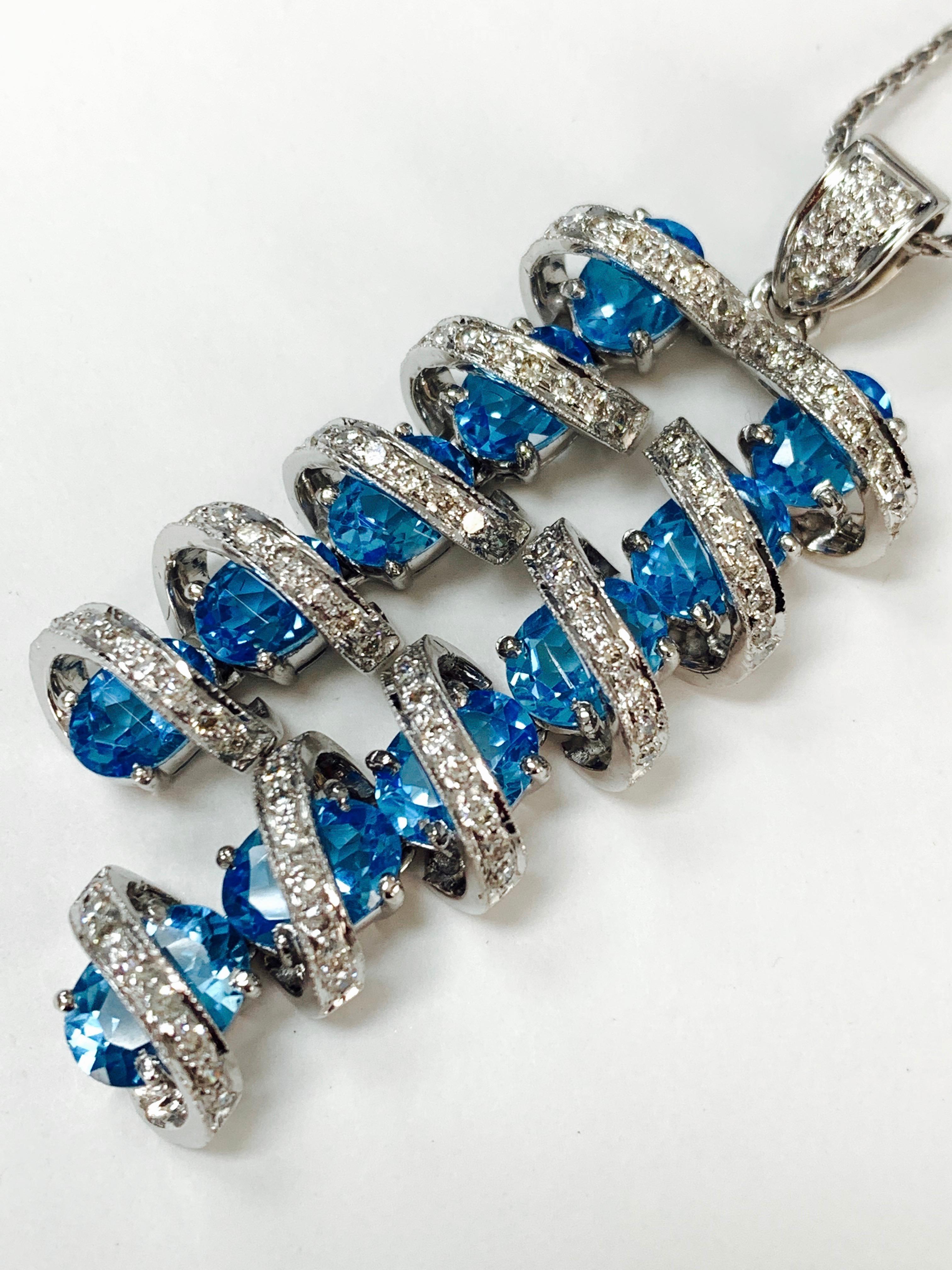 Very beautifully handcrafted white diamond and blue topaz pendant in 18K white gold. 
The details are as follows : 
Diamond weight : 1.25 carat  ( GH color and VS clarity ) 
Blue Topaz weight : 11 carat 
Metal : 18 K White Gold. 
Measurements : 2