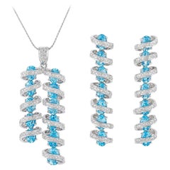 Colgante de diamante brillante redondo blanco y topacio azul ovalado en oro de 18 quilates