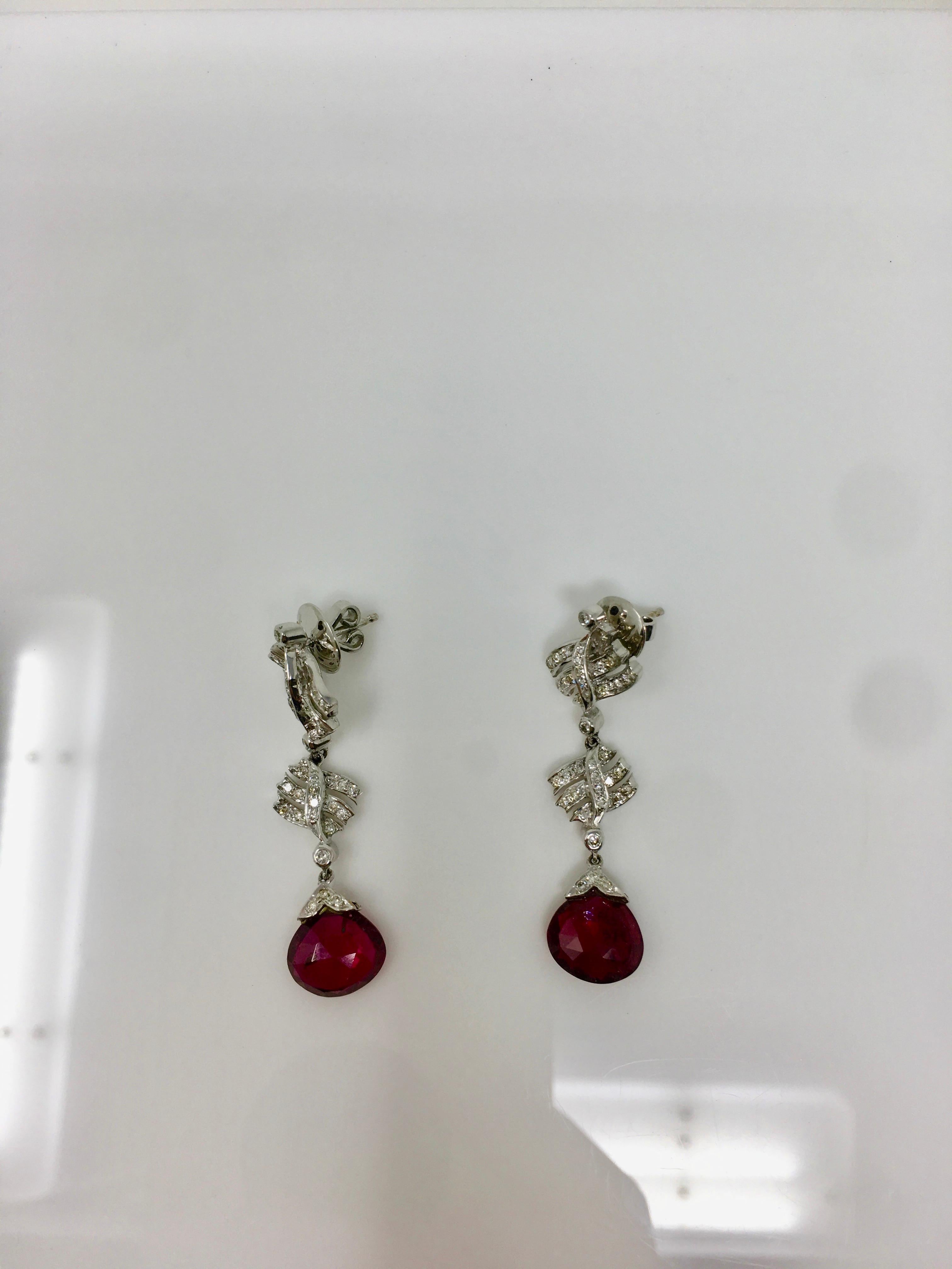 These beautiful earrings finely handcrafted in 18k white gold features white round brilliant diamonds weighing 0.82 carat( VS clarity-GH color) and rubelites. The gold weight is 8.700 grams. The length of the earrings is 1.50 inches. 