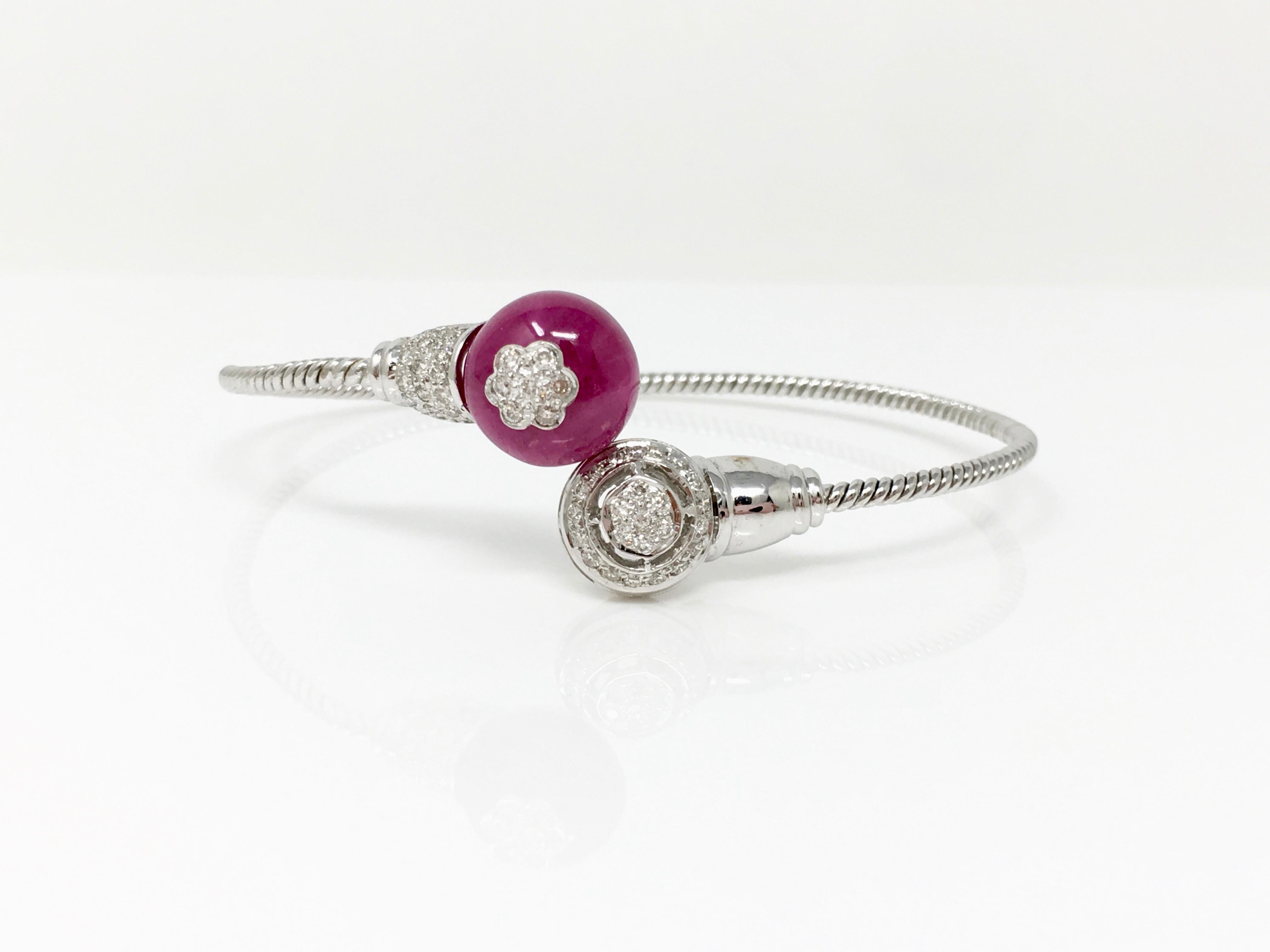 Gorgeous, elegant , perfect , flexible and adaptable bangle features rubellite weighing 14 carat and white round brilliant diamond weighing 0.62 carat ( GH color and VS clarity). This is beautifully hand created by Moguldiam inc in 18k white gold.