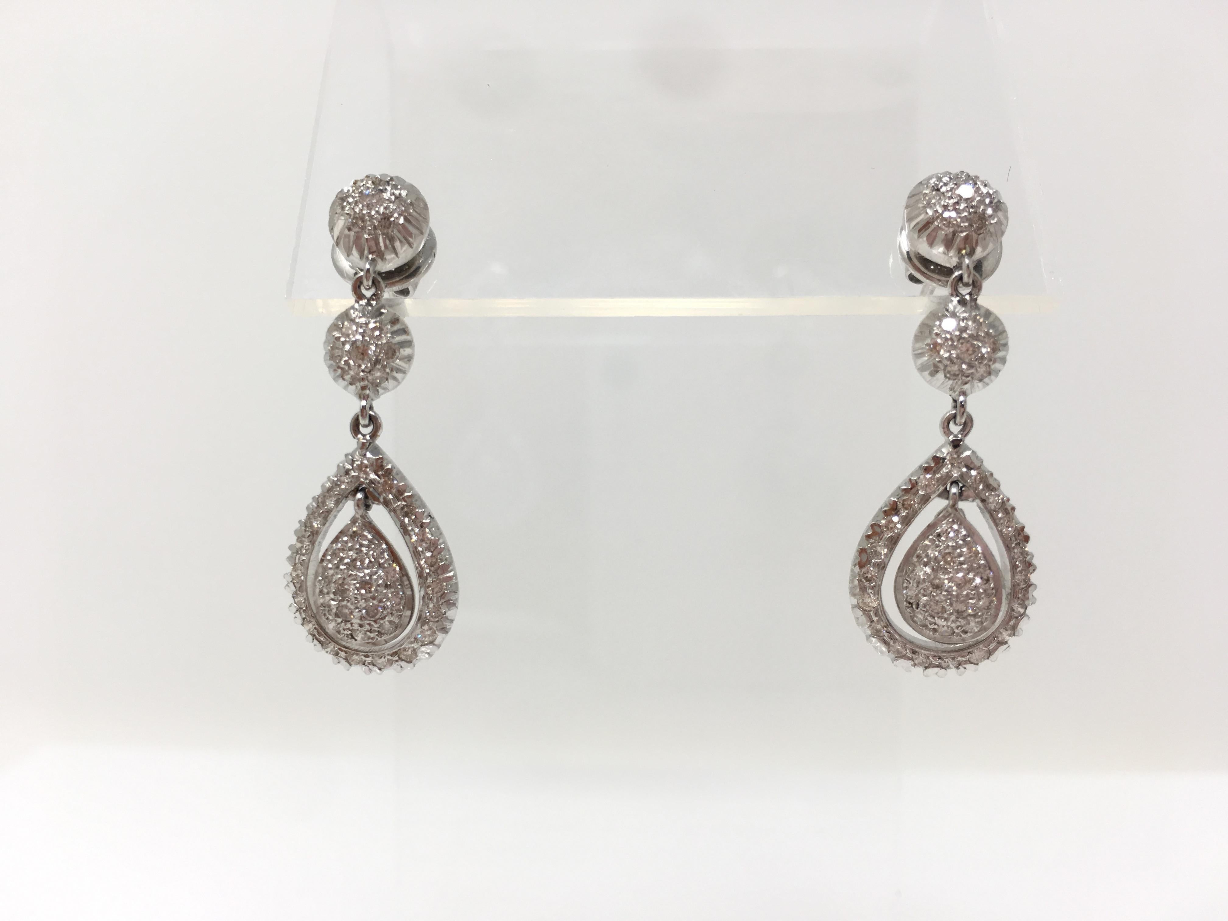 This gorgeous pendant set is beautifully custom hand made in 18k white gold. This pendant set includes pave set white round brilliant diamonds dangle earrings weighing 0.91 carat ( VS clarity and GH color) and a pave set diamond pendant weighing