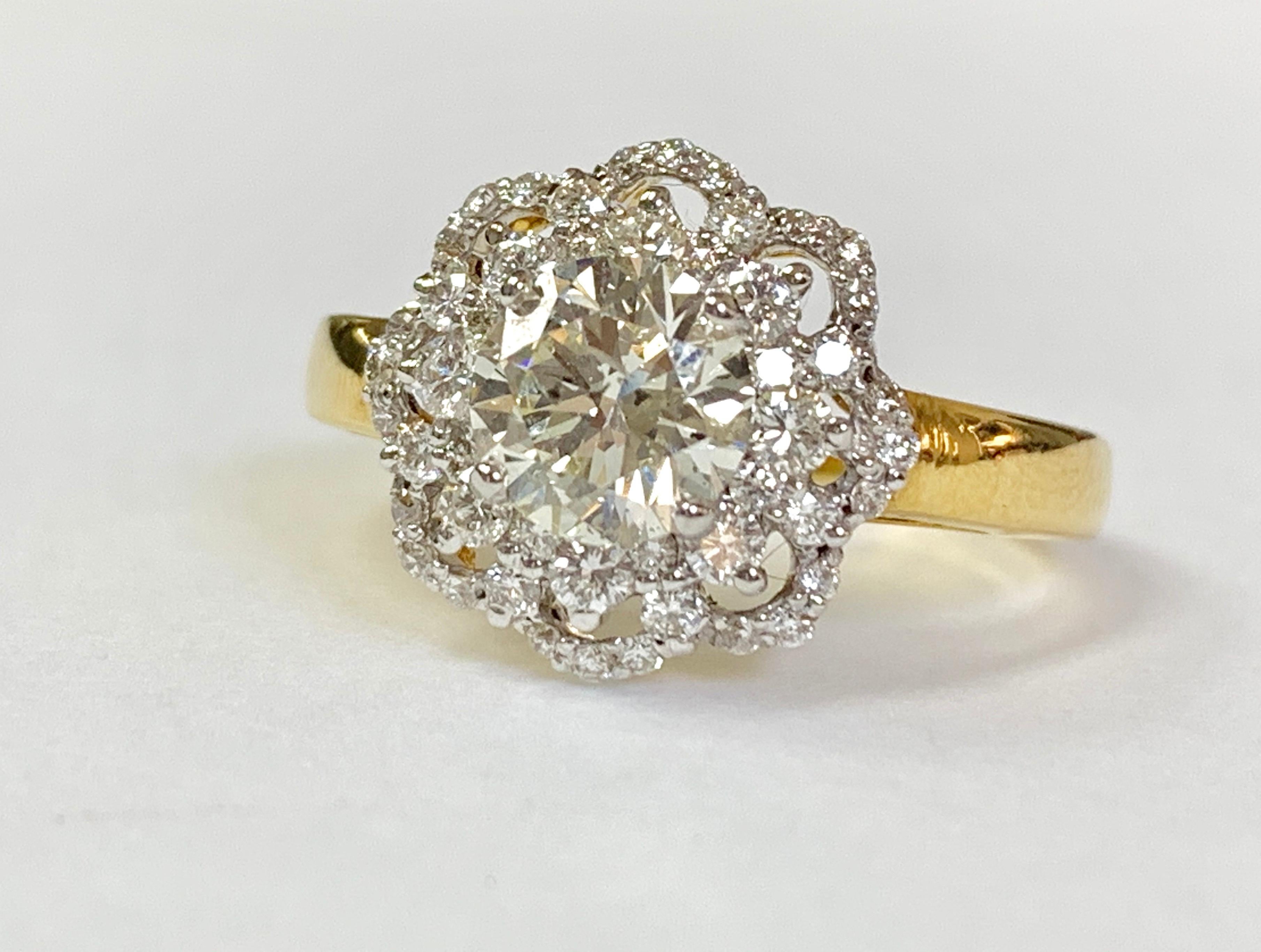 Moguldiam Inc White Round Brilliant Diamond Engagement Ring custom hand made in 18 K yellow Gold. 
The details are as follows ; 
Diamond  weight : 1.03 carat ( center ) 
Small diamond weight : 0.53 carat 
Metal : 18k yellow gold 
Ring size : 5 1/2 

