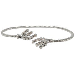 White Round Brilliant Diamond Flexible Bangle In 18K White Gold.