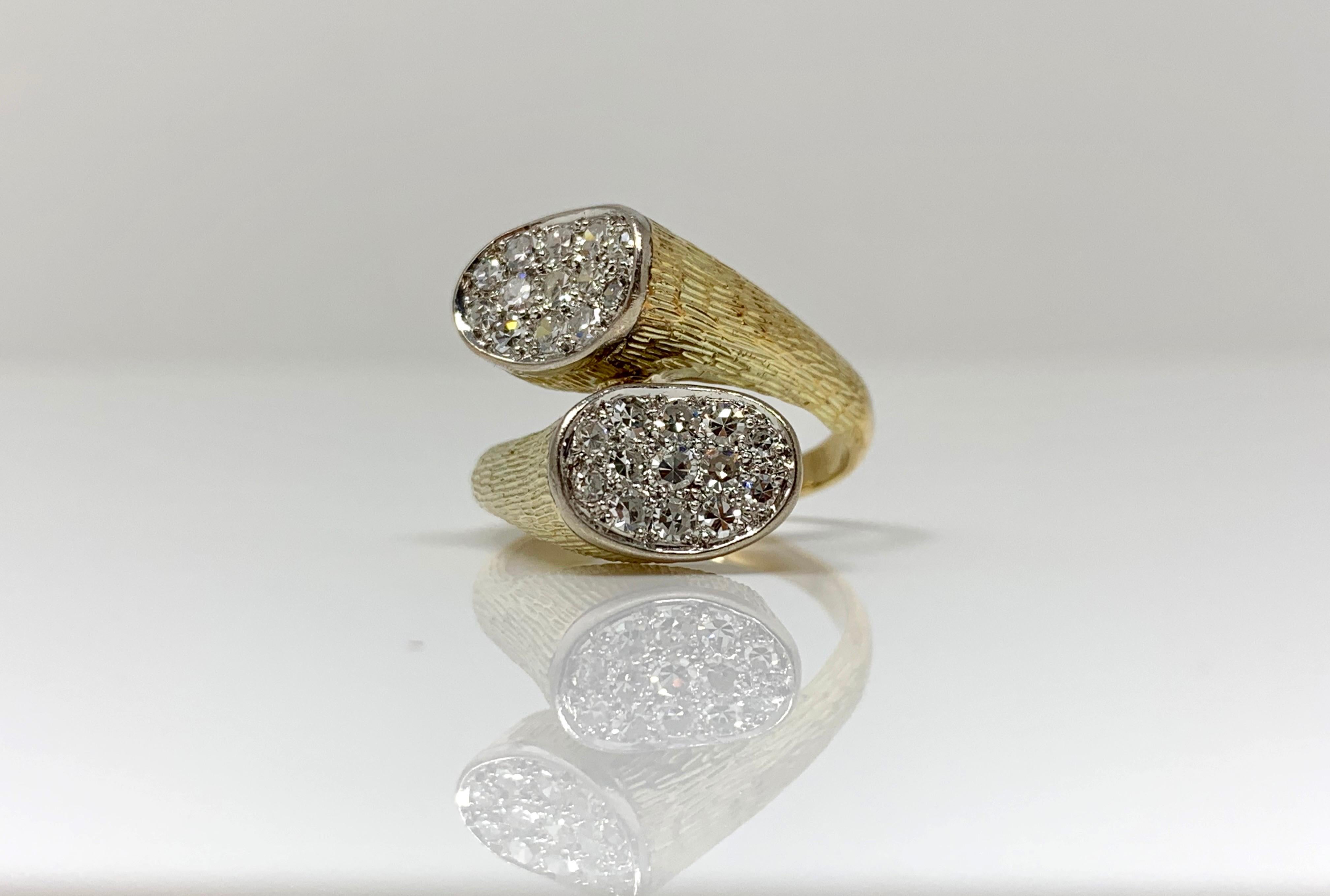 This unique pave set white diamond ring is hand crafted in 14k yellow gold. The white diamond weighs 0.75 carat with VS clarity and GH color . The ring size is 5 3/4. 