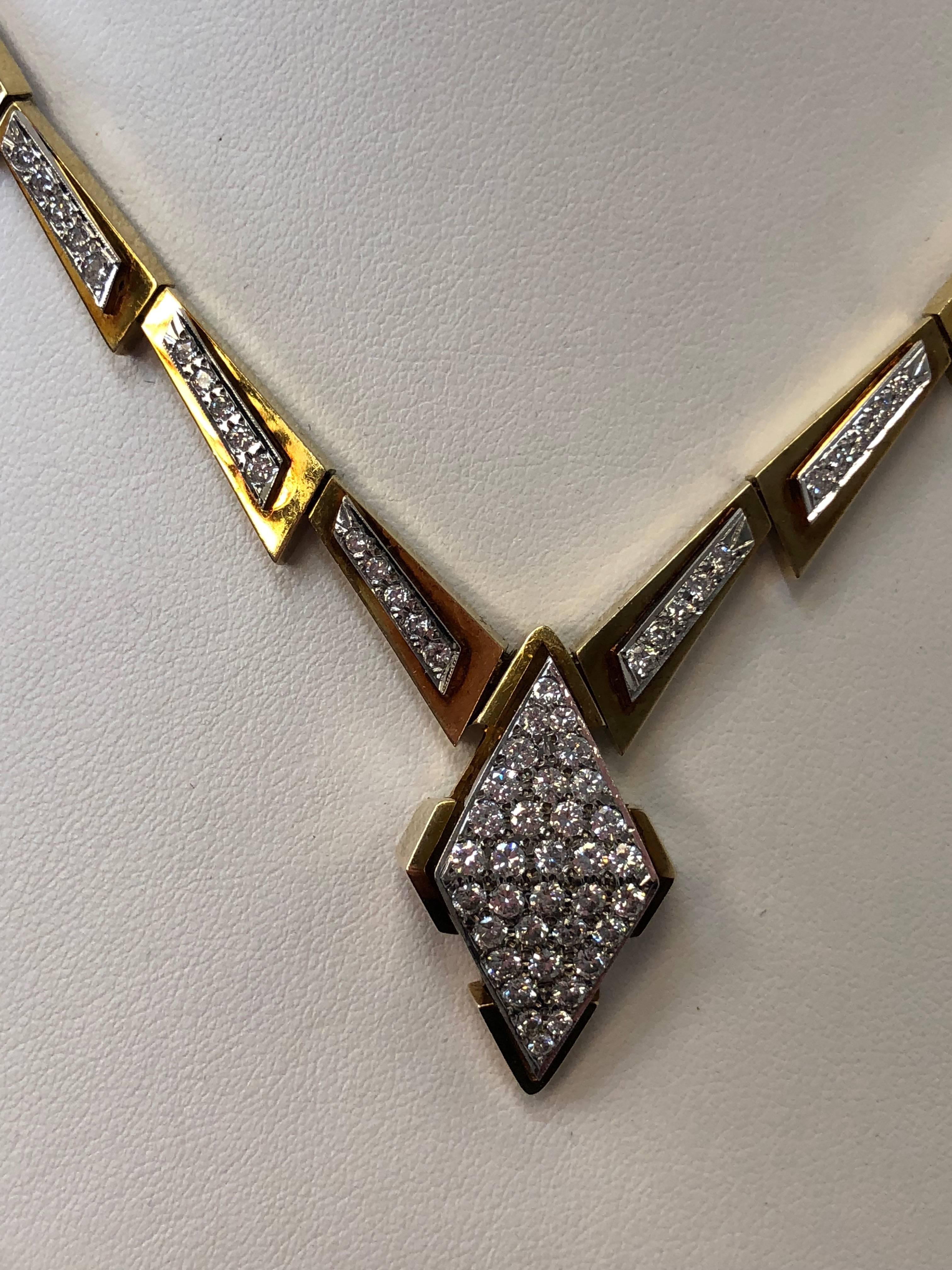 2.50 carats of white diamond rounds in this unique design.  This necklace is in 14k yellow gold and 18