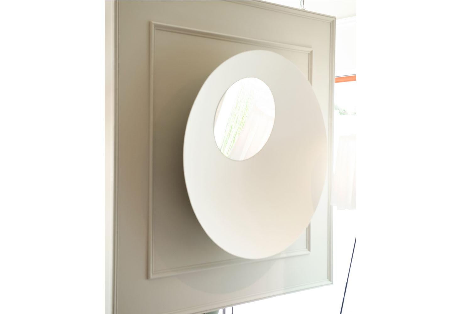 B.olla mirror by Imperfetto

The image reflected in a mirror disc is guarded by another perfect circle. Framed by the wall from which it emerges, the incredible design of this mirror captures, deceives and finally enchants the eye, in an illusory