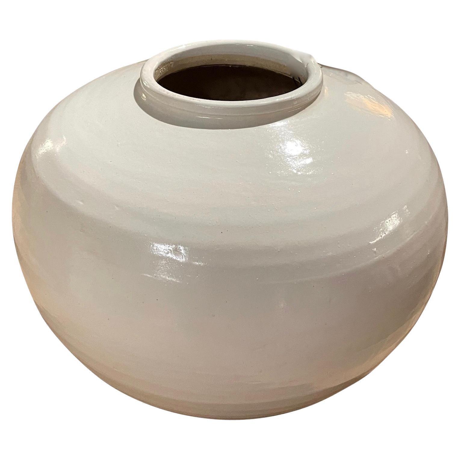 Contemporary Chinese round and squat shaped large white ceramic vase.
From a large collection in a variety of shapes and sizes.