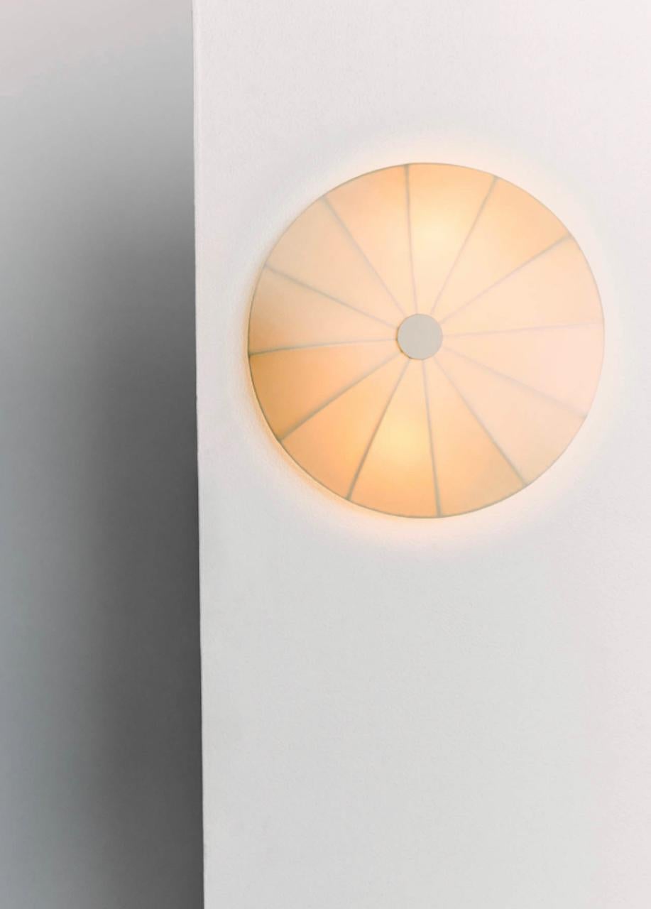 Brand new Ruemmler contemporary white sconce. Clean and sleek sconce for a contemporary look. Includes wiring and shade.