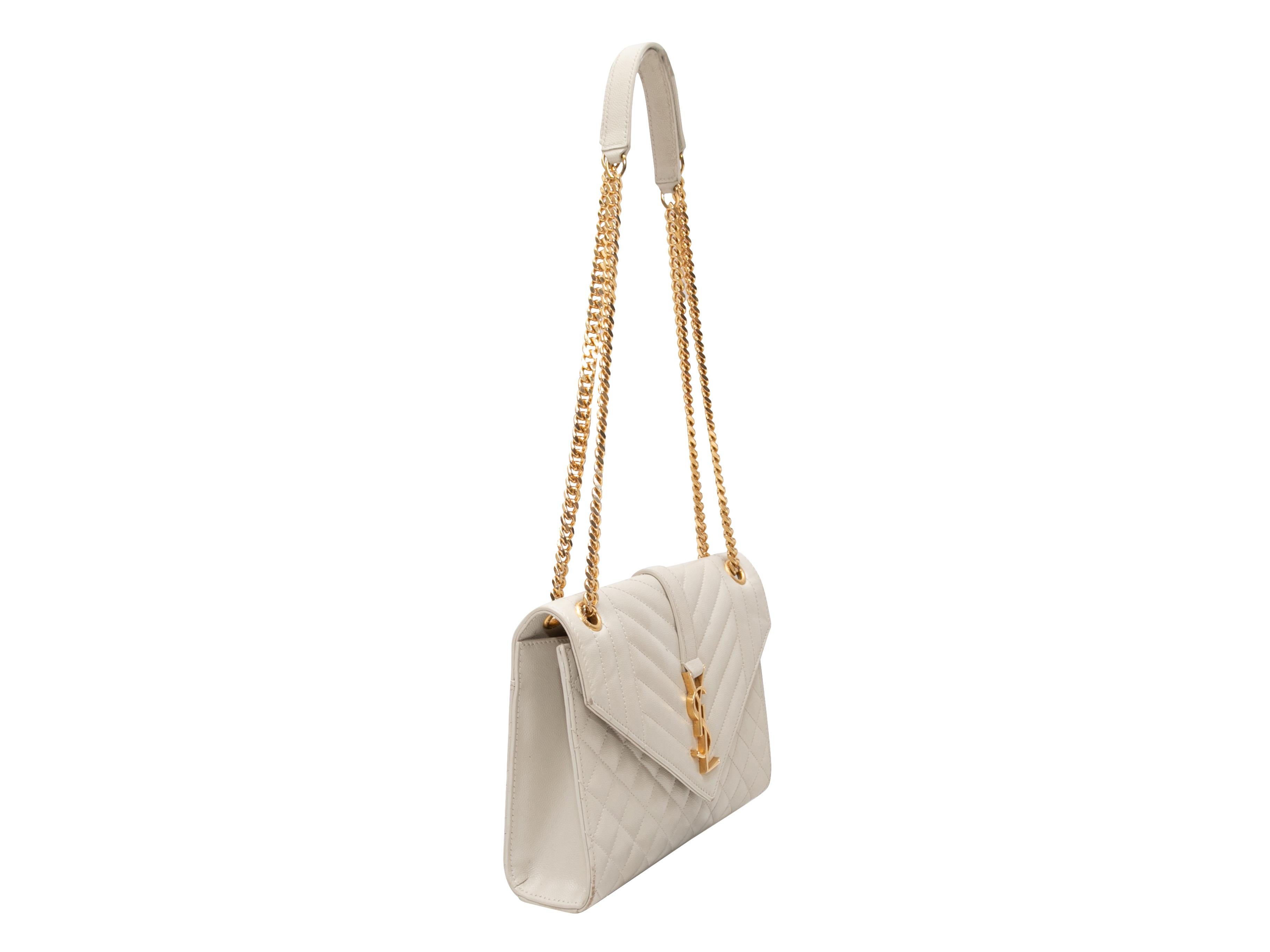 White Saint Laurent Medium Triquilt Matelasse Envelope Bag. The Medium Triquilt Matelasse Envelope Bag features a leather body, gold-tone hardware, dual chain-link and leather straps, and a front flap closure. 9.5